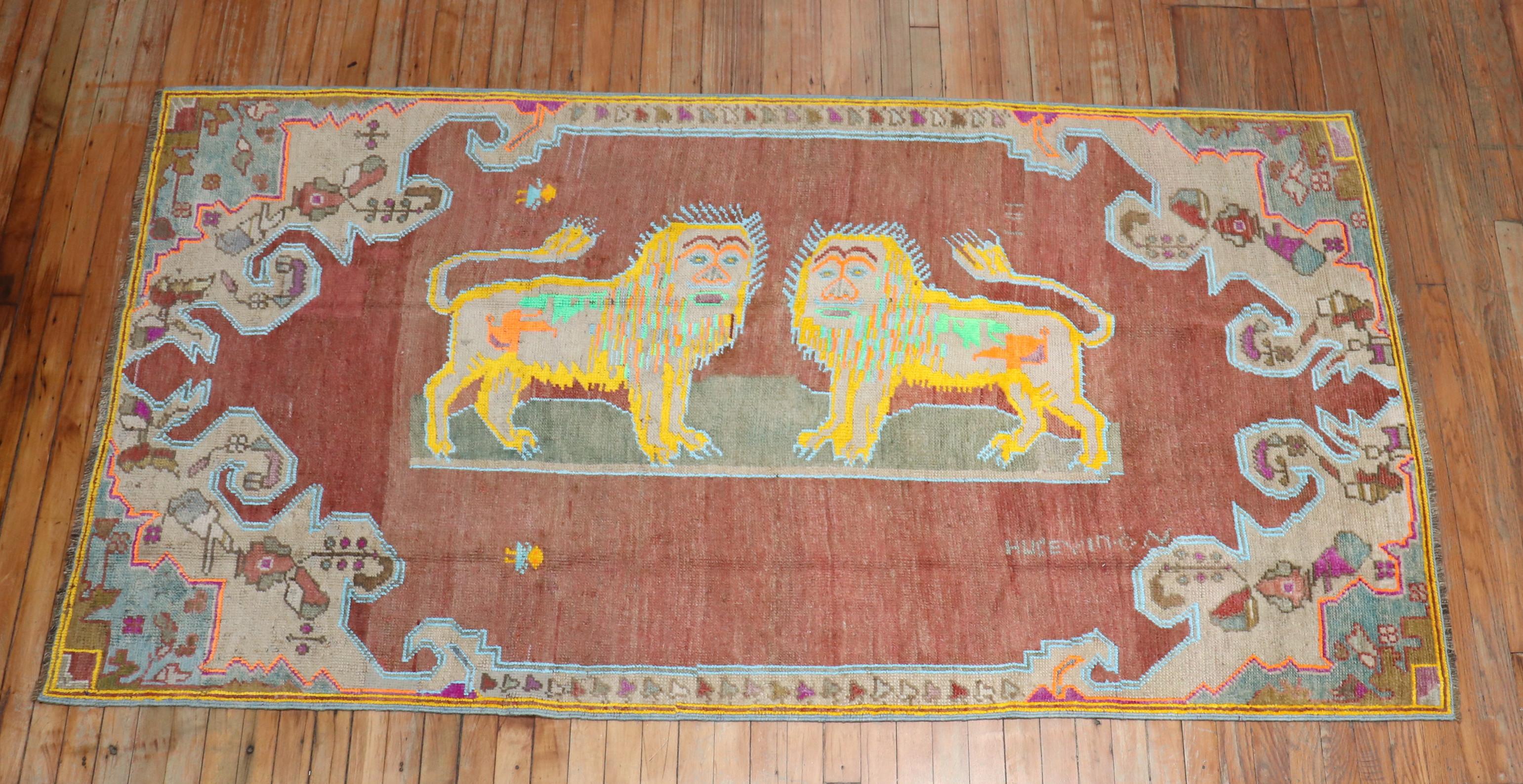A mid-20th century pictorial double lion pictorial rug.

Measures: 4' x 7'7''.