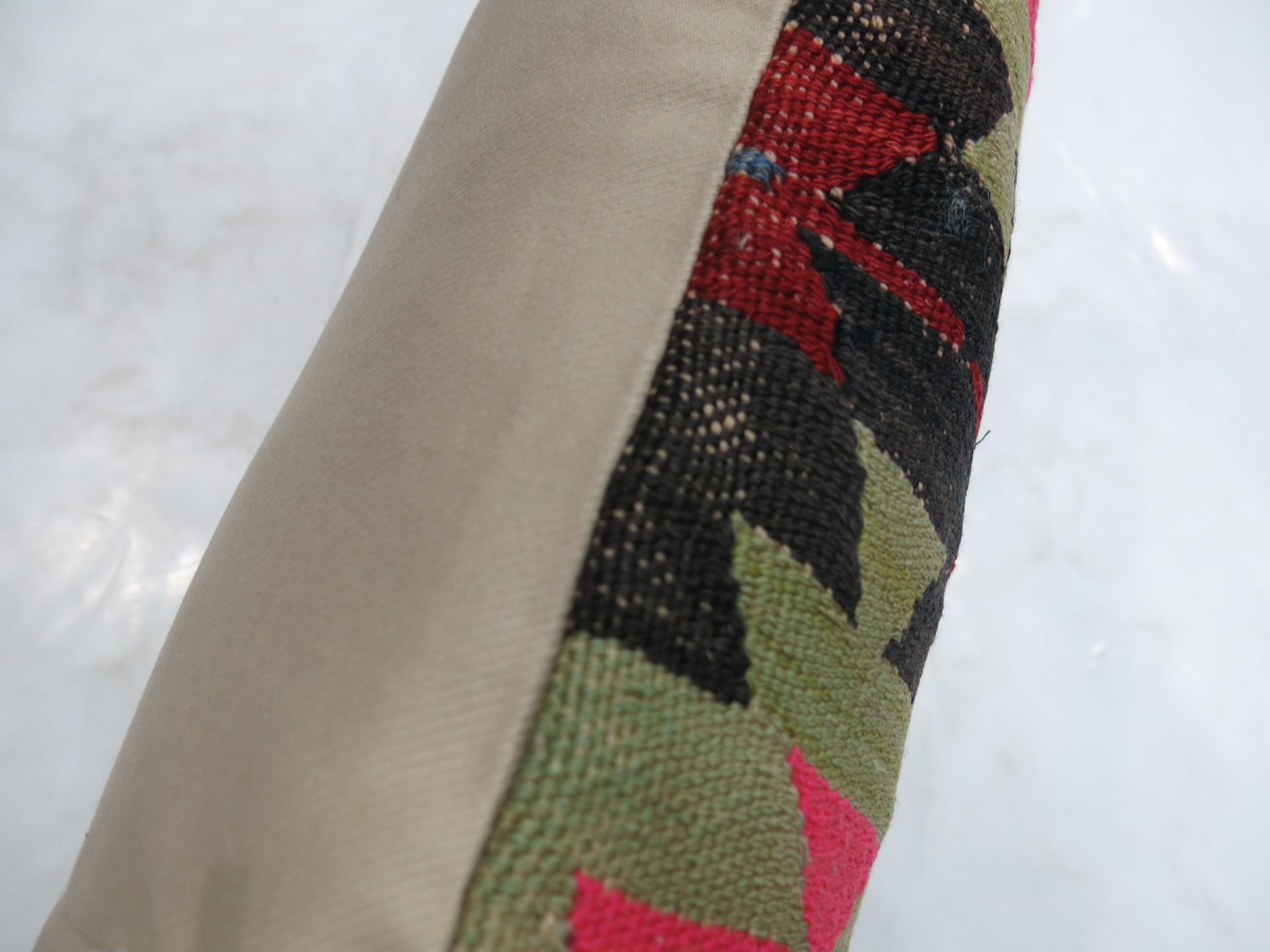 Pillow made from a vintage Turkish Kilim with dominant accents in black and bright pink.

Measures: 16
