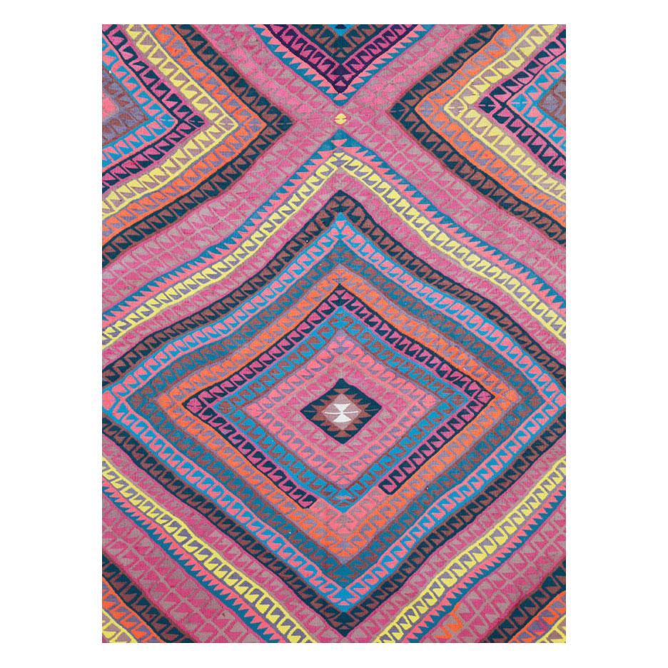 A vintage Turkish flat-weave Kilim room-size carpet in square format handmade during the mid-20th century with a colorful contemporary pattern in a tribal manner. The overall effect is vaguely psychedelic.

Measures: 11' 8