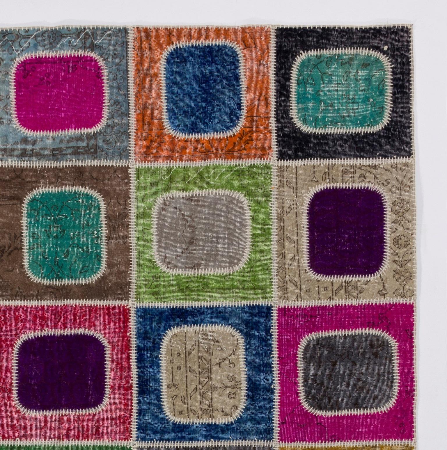 Assorted pieces of mid-20th century hand knotted Turkish rugs that were washed, sheared, re-dyed in various colors and cut into geometric shapes were stitched together by hand in couple of weeks to create this one-of-a-kind patchwork rug. A durable