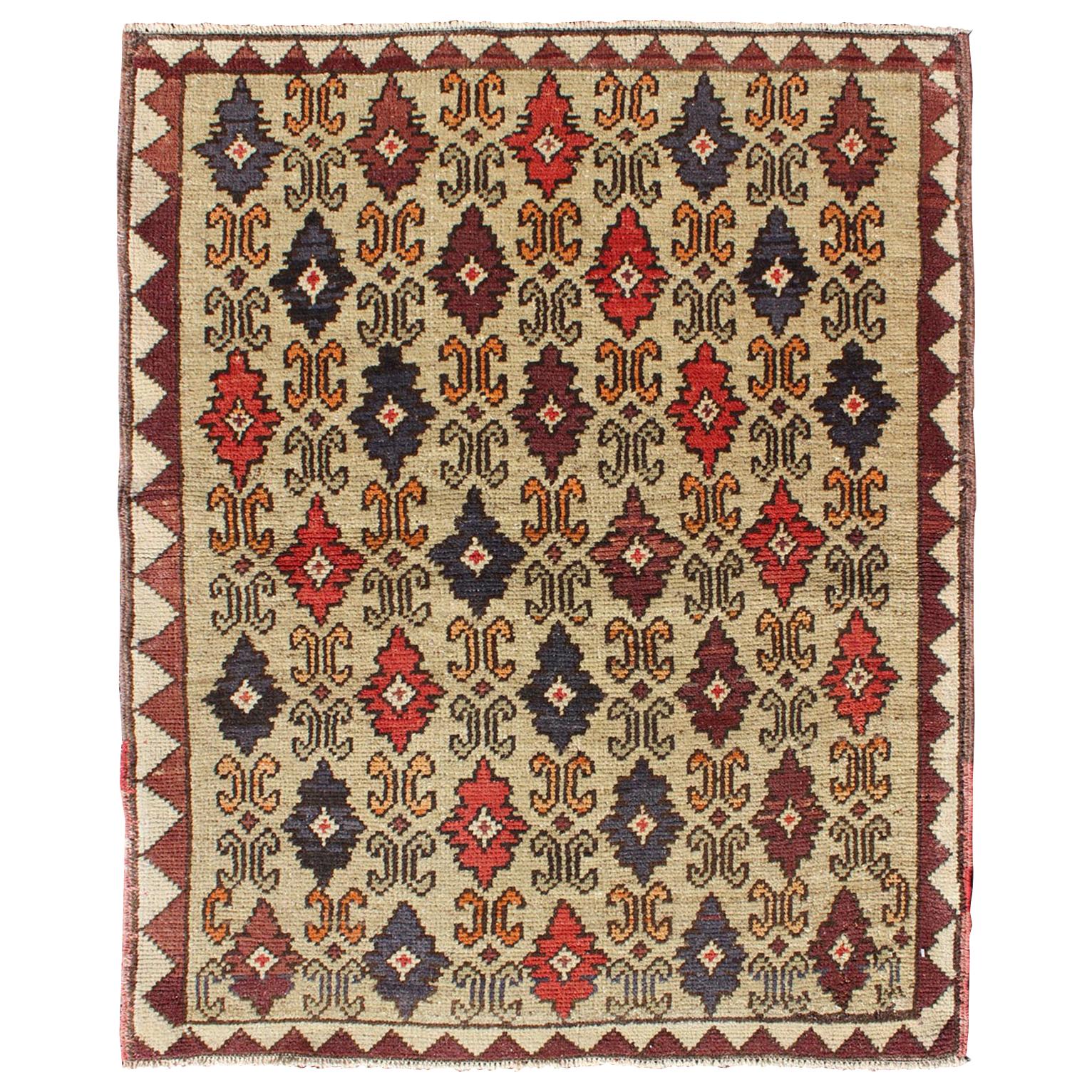 Colorful Midcentury Turkish Tulu Rug with Repeating Design Set on Wheat Field