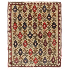 Vintage Colorful Midcentury Turkish Tulu Rug with Repeating Design Set on Wheat Field