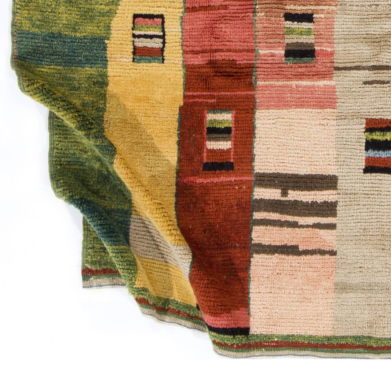 A colorful modern hand-knotted rug from Central Turkey with a soft, organic lambs' wool pile, which is durable, cozy and comfortable. The rug itself features a modern design of striated color blocks in soft yellow, tomato red, salmon pink and