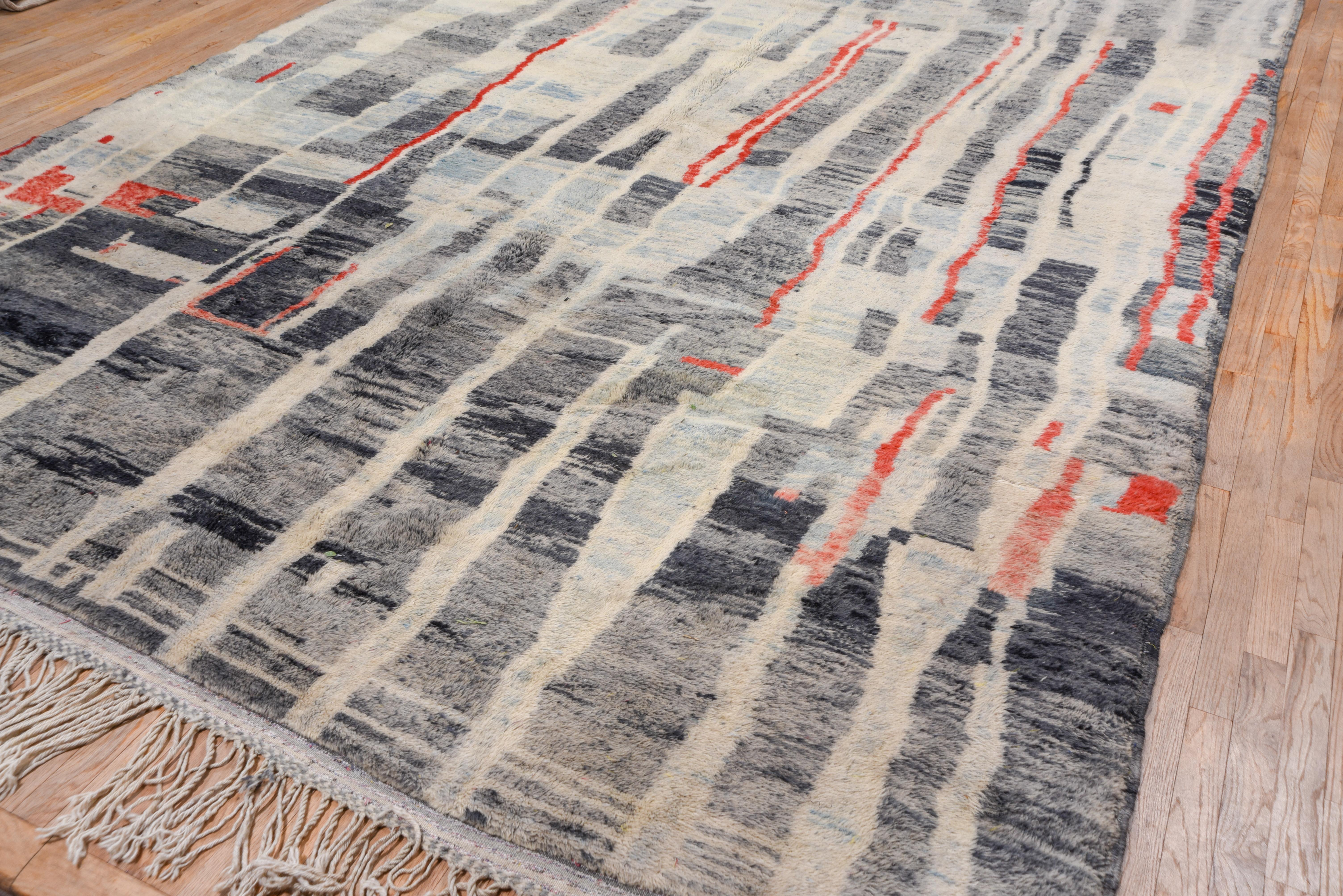 Borderless, with pale blue, ivory and rust broken stripes dissecting the impossibly abrashed slate blue ground. Thick pile, abstract and contemporary. Make a statement with this gorgeous colorful Moroccan carpet!
