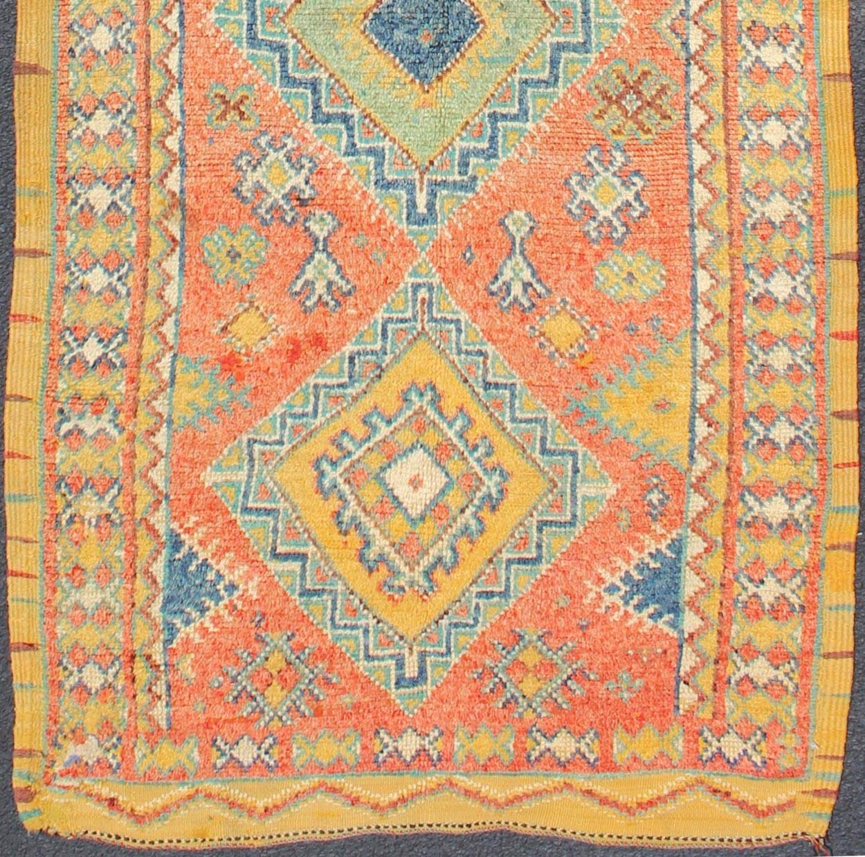 Colorful Moroccan Runner in Orange, Blue, Yellow and Gold Colors.
Rendered with four medallions and random spotted and speckled shapes, this unique Moroccan runner displays a harmonious and rich color palette of oranges, reds, blues, golds and light