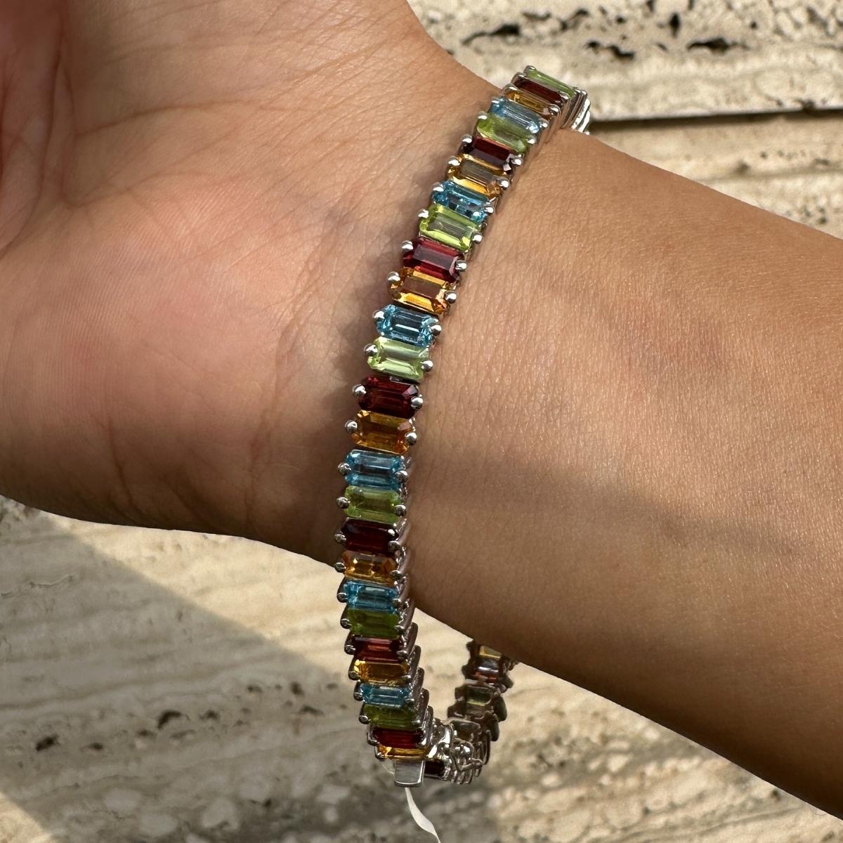 Colorful Multi Gemstone Tennis Bracelet for Her in sterling silver showcases endlessly sparkling natural multi gemstone, weighing 18.94 carat. It measures 7.25 inches long in length. 
Multi Gemstone stimulate concentration and reduces