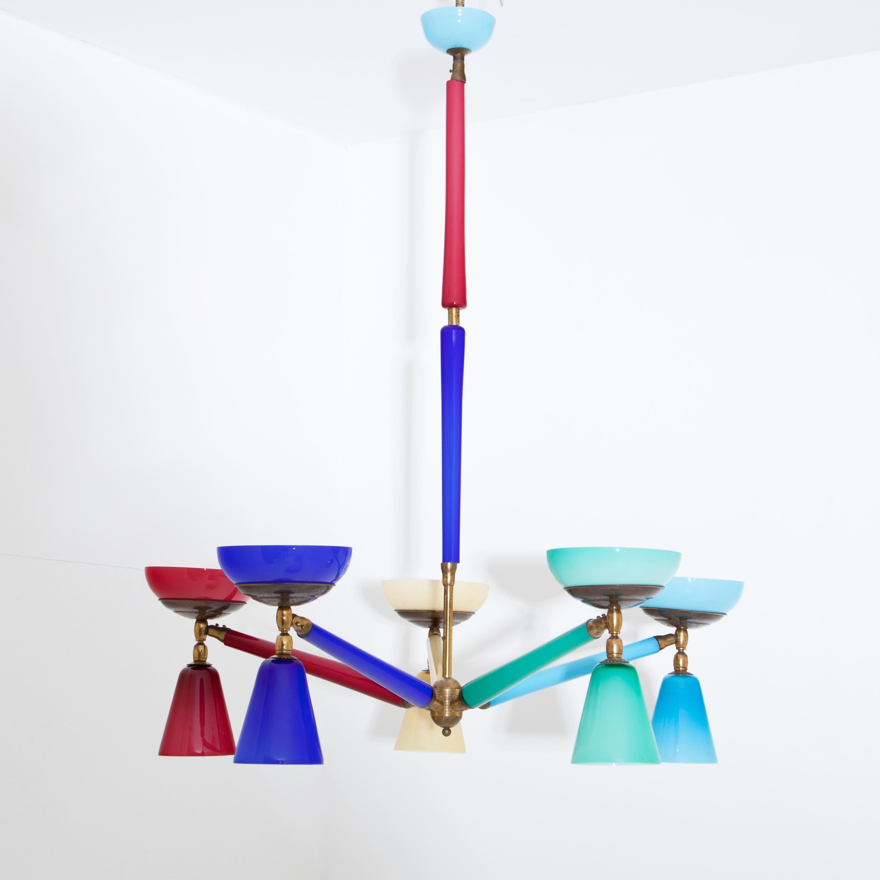 Five-armed colorful Murano glass ceiling chandelier with conical or bowl-shaped lampshades. Each arm is grouped in a different color around the brass rod with further glass elements. The ceiling rosette is in light blue. Some parts are restored. For