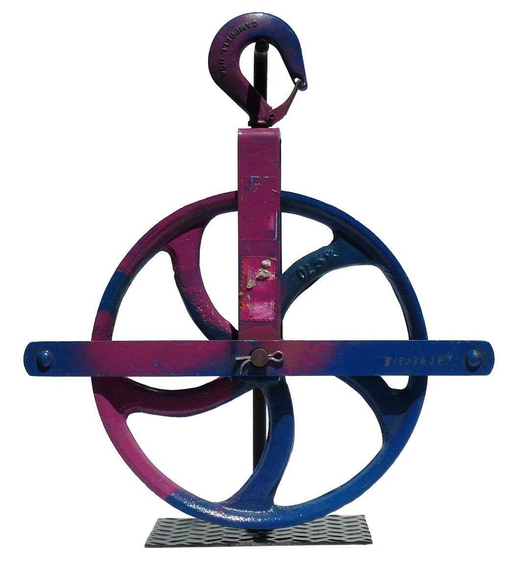This is a colorful, large industrial cast iron pulley with older working overpaint.This pulley is painted bright blue and pink. It measures 17 3/4