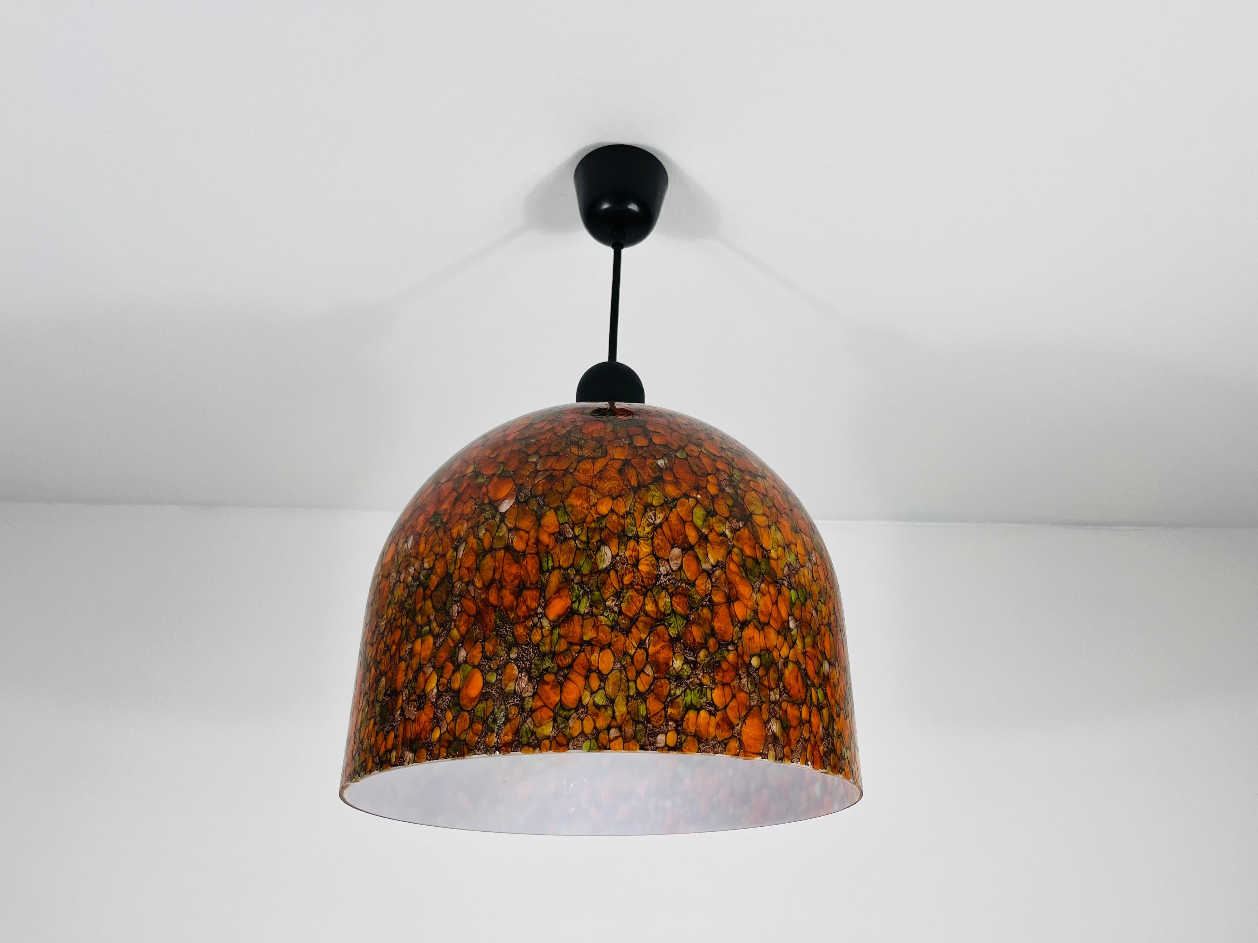Eine Pendelleuchte von Peill und Putzler, hergestellt in Deutschland in den 1970er Jahren. Sie fasziniert durch ihre seltene Mosaikglasform. Der Lampenschirm hat orange und grüne Farben.

Abmessungen:

Höhe: 28-52 cm
Durchmesser: 30 cm

Die Leuchte