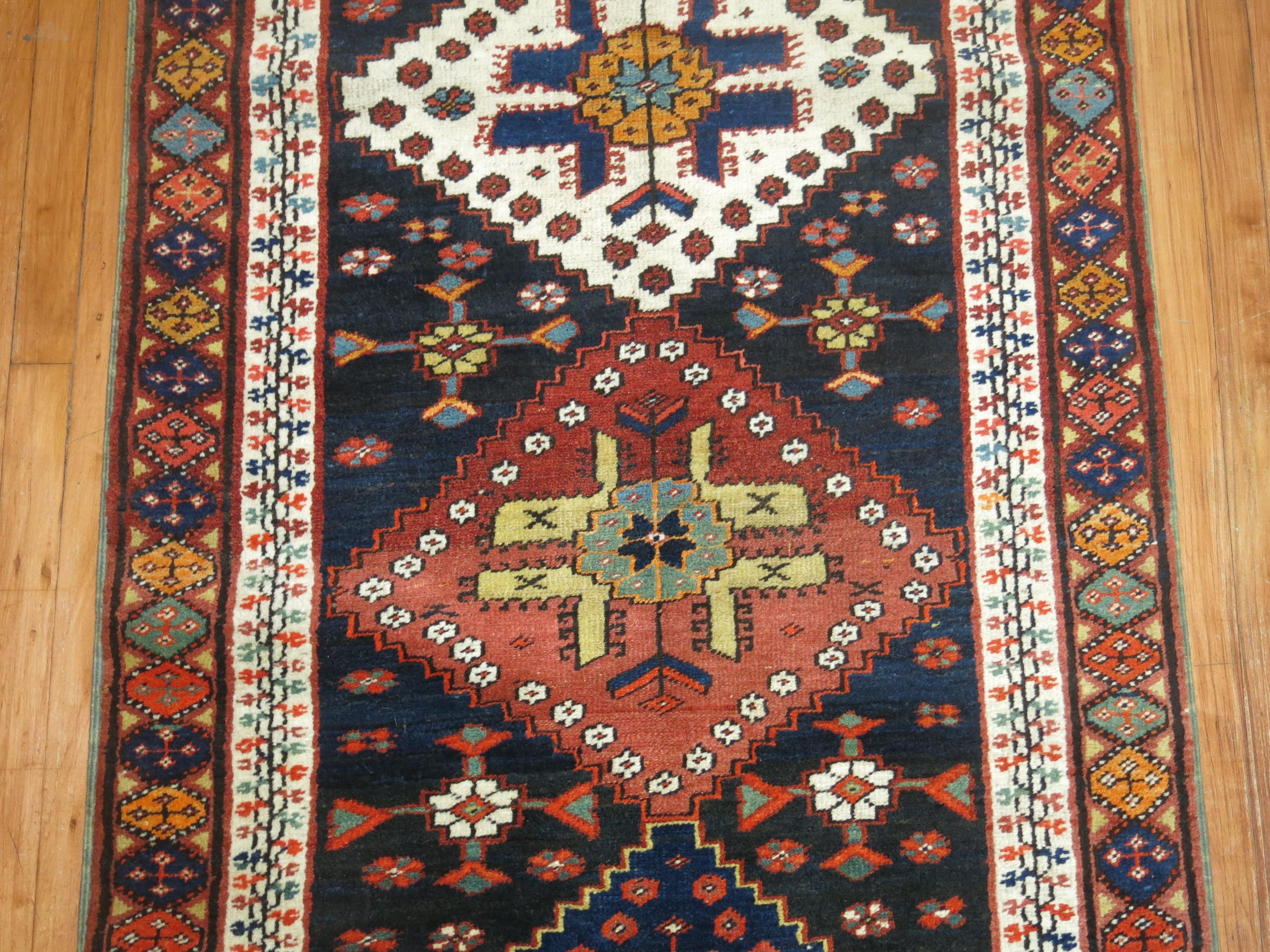 Early 20th century Persian Kurd runner with a bold geometric design on a navy ground

Measures: 3'1' x 15'8