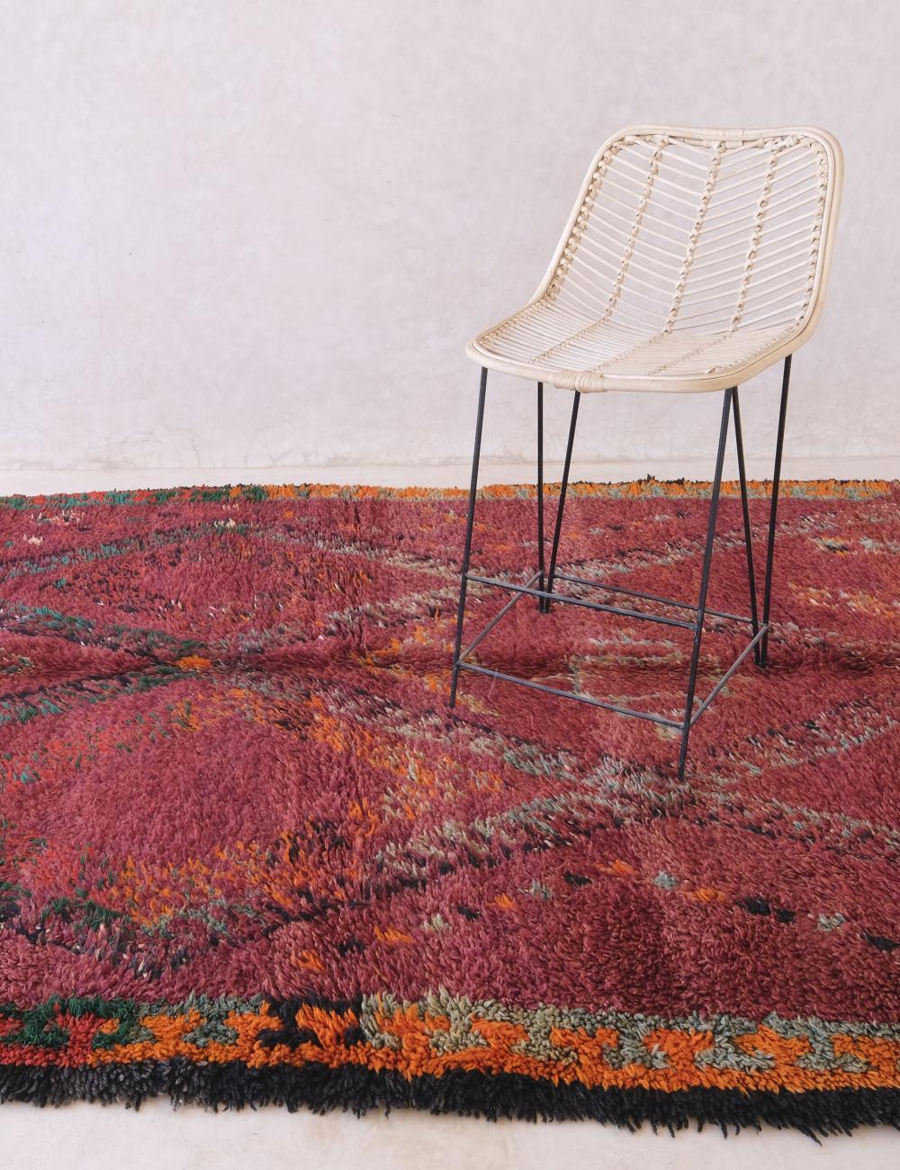 Si tratta di un favoloso tappeto marocchino vintage da collezione realizzato a mano dalla tribù degli Zayan. Questo tappeto ricco e colorato è caratterizzato da una base di lana rossastra e da simboli berberi intrecciati in modo unico in un motivo a