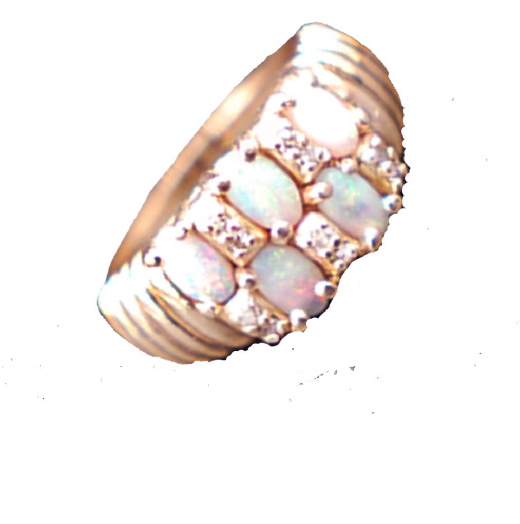 

14 Karat yellow gold Corrugated style ring featuring Fire Opals and Diamonds. The ring is in a band style and measures 9.73 mm wide at the top and graduating down nicely to a 3.20 mm behind the finger.
The opals measure 5.5 x 3.5 mm, oval in shape
