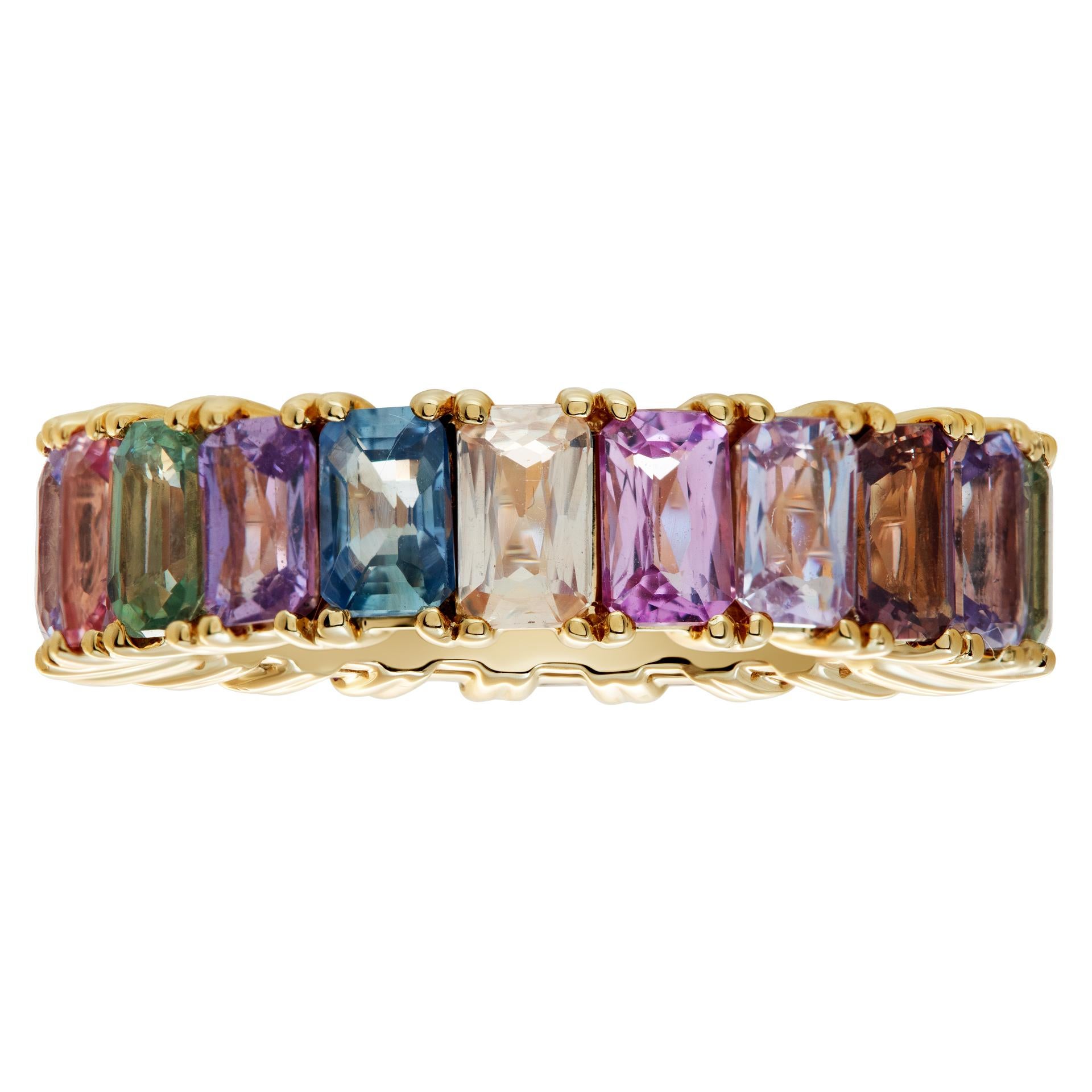 Colorful sapphire eternity band in 14k yellow gold with 7.80 carats in green, pink, blue, orange, yellow and purple colored emerald-cut sapphires. Size 7, width 6mm.This Sapphire ring is currently size 7 and some items can be sized up or down,