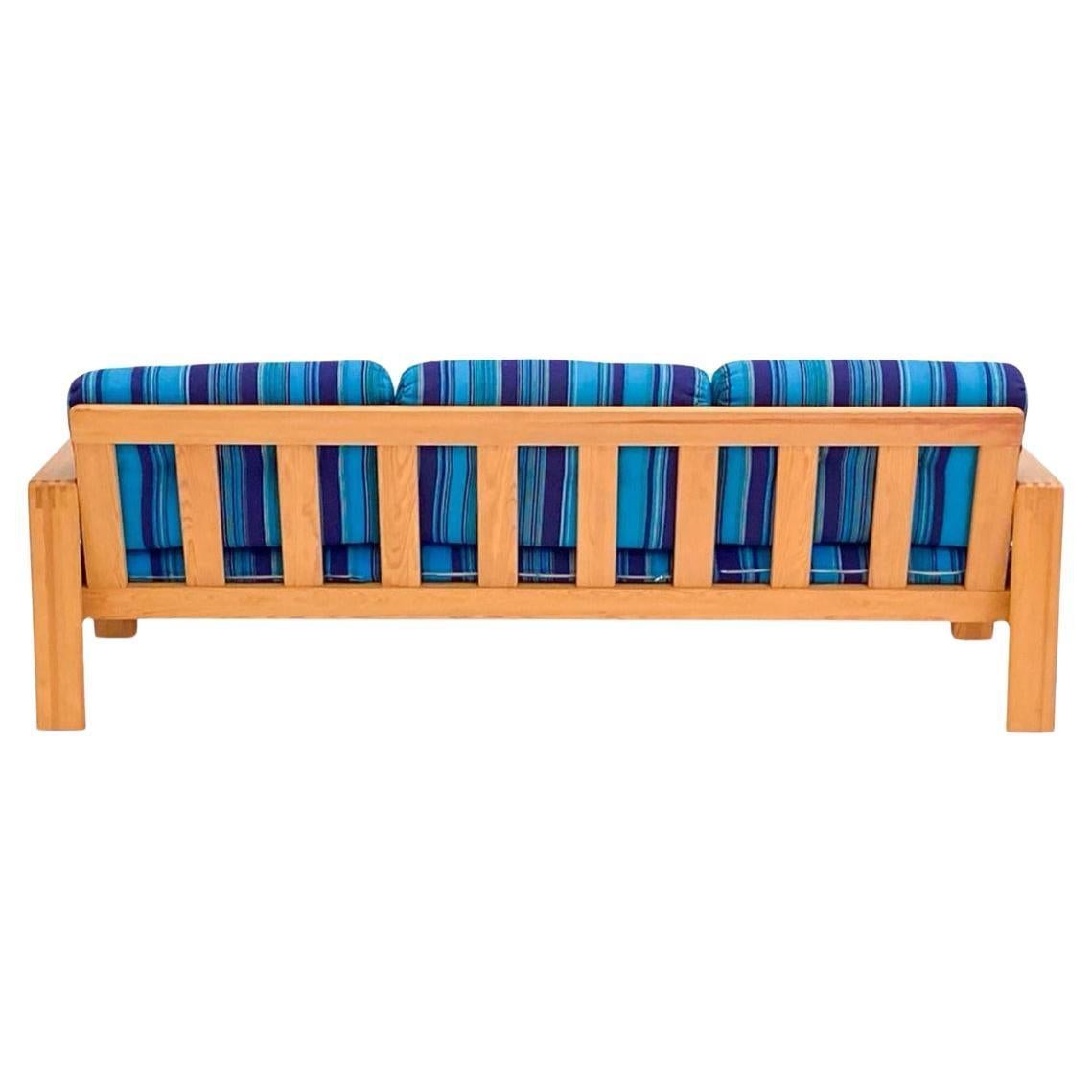 Colorful Scandinavian modern pine 3 seat sofa or daybed made in Sweden. Has 3 lower cushions with 3 back cushions. Upholstery is tufted bright blue and purple stripes foam is high quality and in great condition. The frame is very sturdy and made of