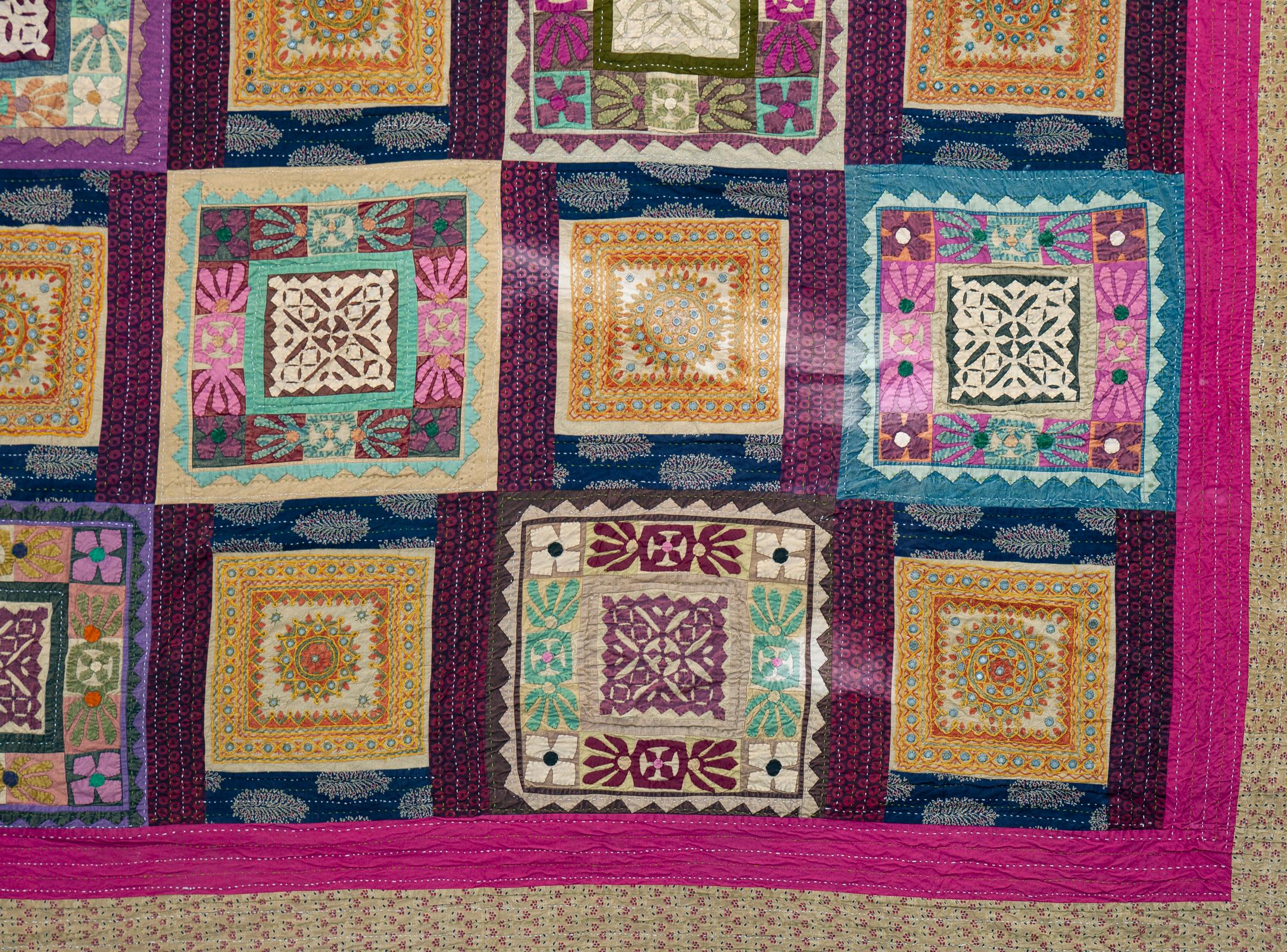 Colorful patchwork textile with 20 intricate squares, handmade from India.
Use as wall hanging, bedspread or throw.