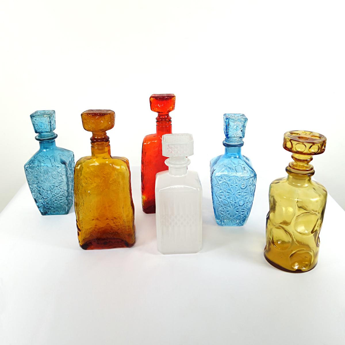 Very colorful and decorative set of six Italian glass decanters. There is one white decanter, one red, two brown and two blue ones.
All carafes have a stopper.

Dimensions in cms:
2x brown 
Height 24.5 x diameter 10 
H 27.5 x W 11 x D 6 

2x