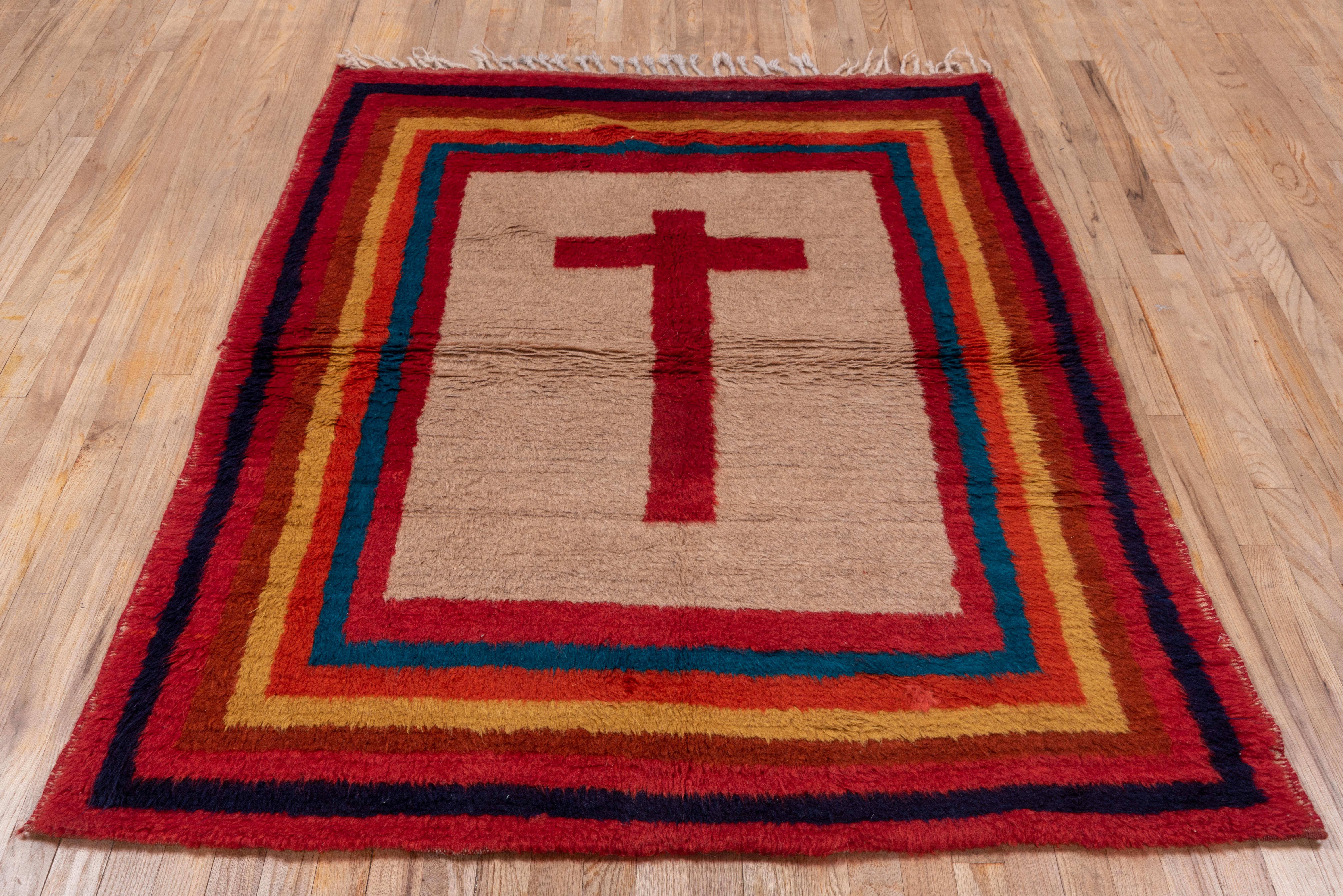 Christian aestheric, , but this is a Qashghai Gabbeh that was made by Islamic nomads, and displays  a red cross on a plain light brown ground, within numerous plain borders in  yellow, red, rust and blue. Tassels at one end intact,. Makes a striking