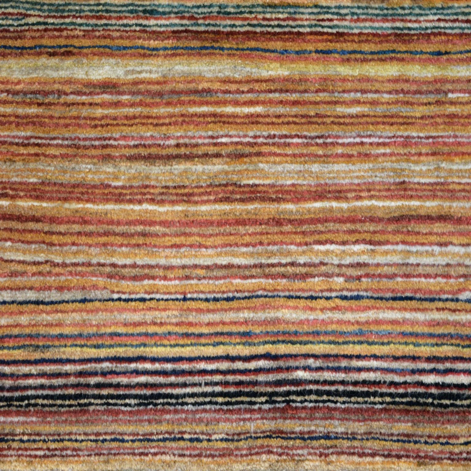 Measuring 3’5” x 3’10”, this colorful Persian wool area rug with a striped design is hand-knotted and belongs to Orley Shabahang’s World Market Collection. During the weaving process, the artisan utilized traditional Persian weaving techniques.