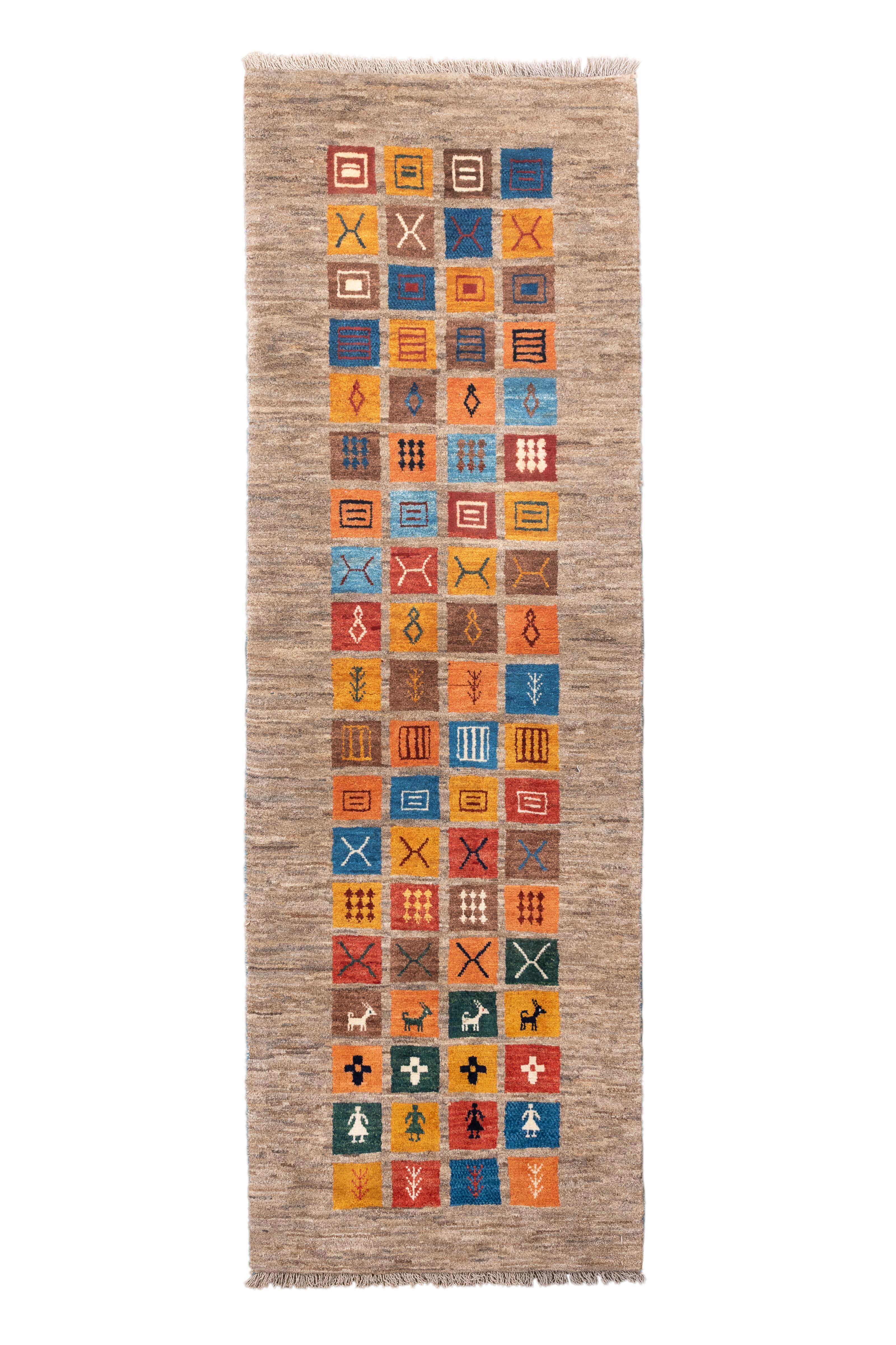  A captivating handwoven Gabbeh runner rug featuring a gallery of tribal symbols in a rhythmic, stacked block format. Set against a natural undyed wool ground, these jewel-toned glyphs—ranging from animals to geometric motifs—offer rich storytelling