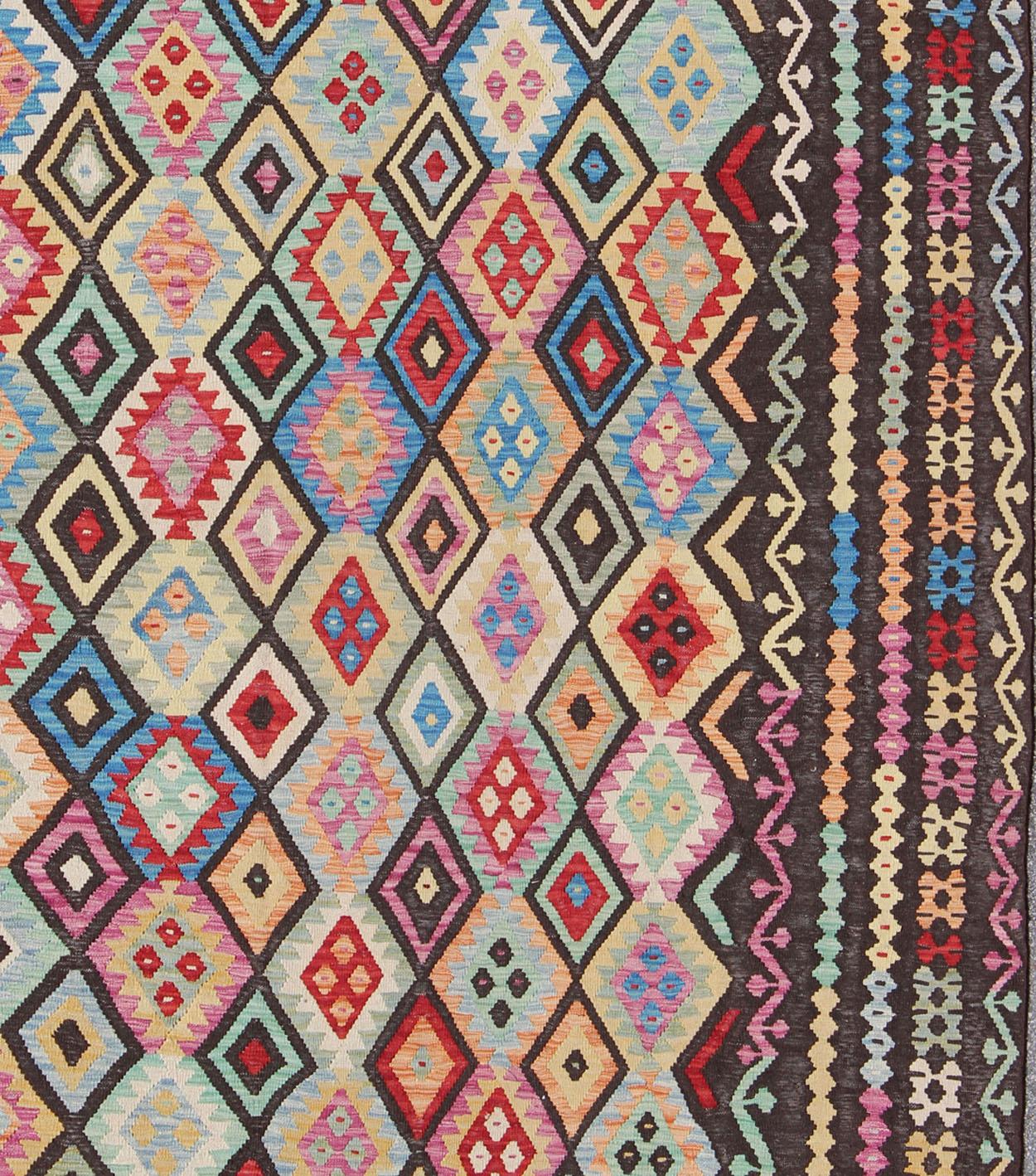 Colorful Tribal Vintage Kilim, rug ABT-8120937, country of origin / type: Afghanistan / Kilim, circa late-20th Century. Keivan Woven Arts, Afghan Kilim Rug. 

This flat-woven kilim rug from Afghanistan features a bold geometric design consisting of
