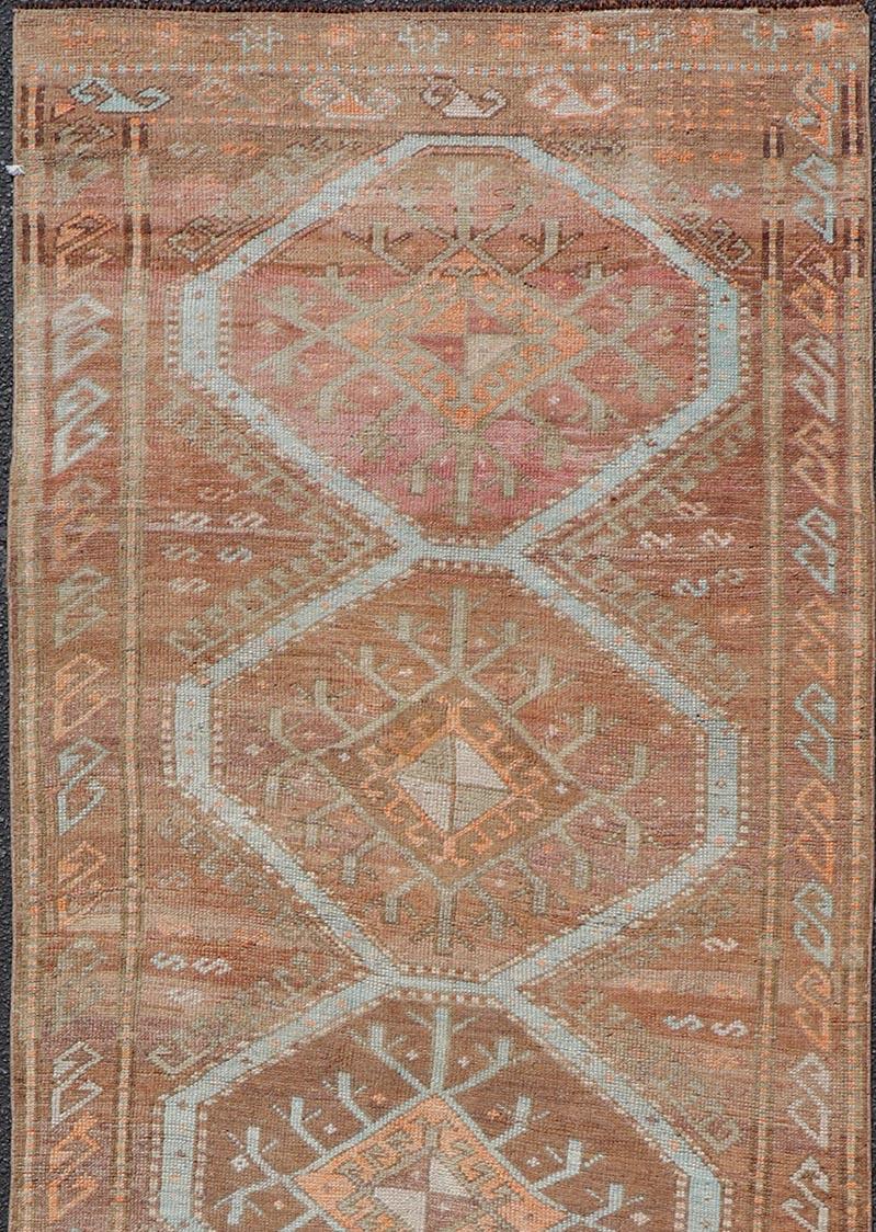 Unique & Colorful Turkish Kars Runner with Tribal and Geometric Motifs. Keivan Woven Arts / rug/EN-15341, country of origin / type: Turkey / Oushak, circa 1930

Measures: 3'9 x 10'9 

This vintage runner features an assortment of tribal and
