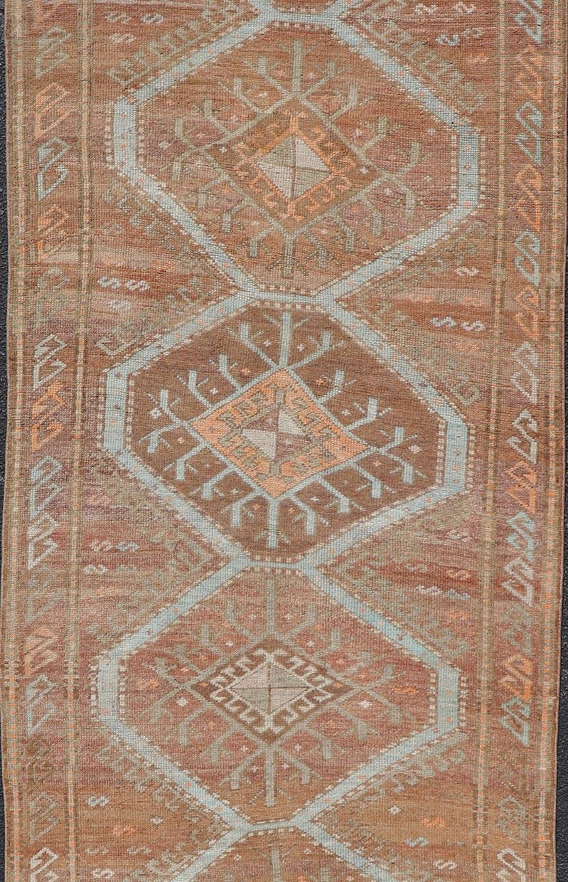 Oushak Colorful Turkish Kars Runner in Softer Tones with Tribal and Geometric Motifs For Sale