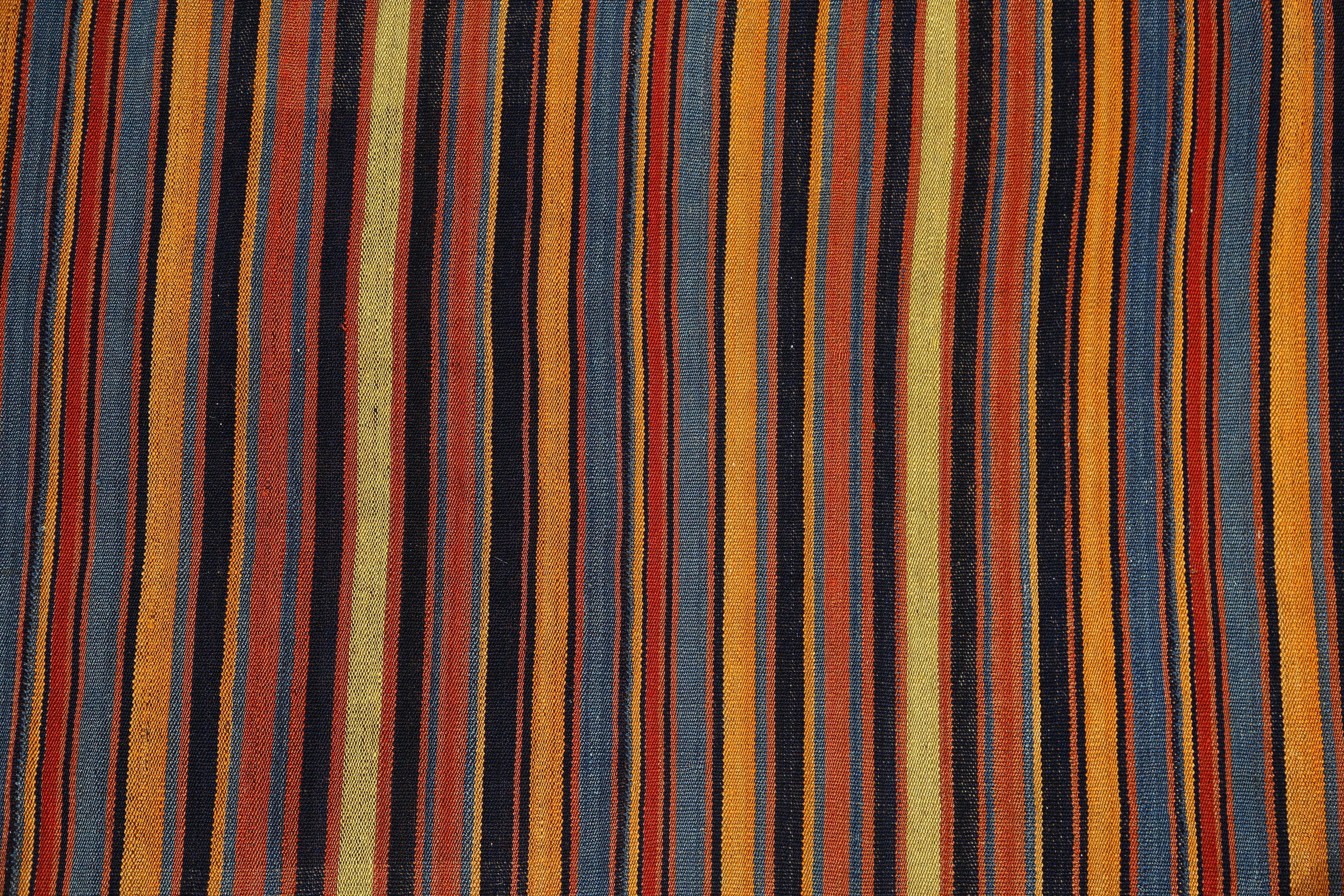 Introducing our handmade Turkish Kilim runner, measuring 3'6'' by 28'7''. This stunning piece features colorful stripes in shades of orange and black, adding a bold touch to any space. Each kilim is carefully crafted by skilled artisans, ensuring a