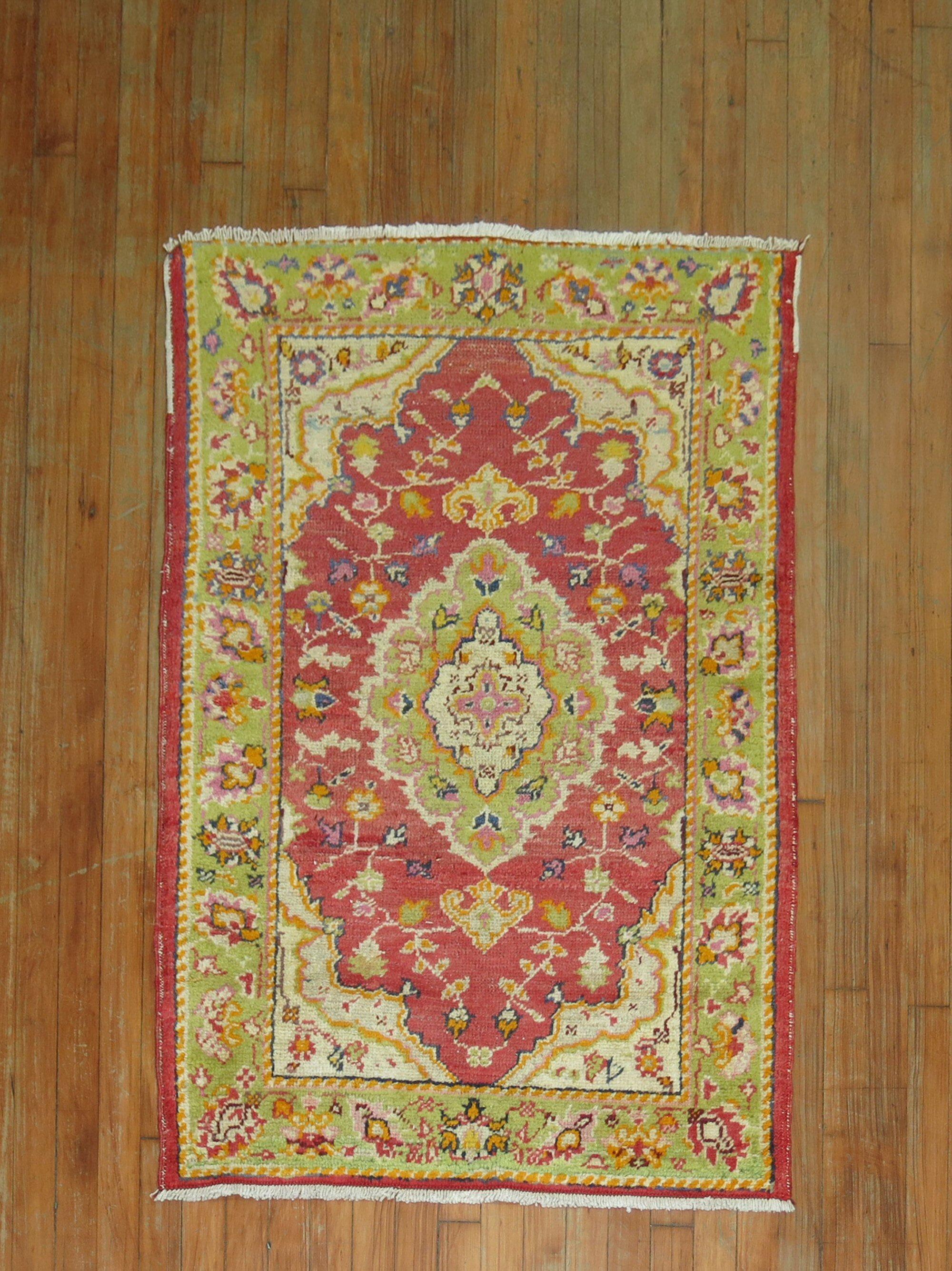 A mid 20th century Turkish rug with a colorful red and green palette

Measures: 2'10'' x 4'1''.