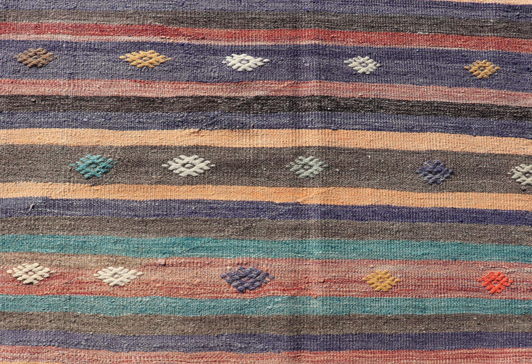 Measures: 3'3 x 10'10 
Colorful vintage embroidered Kilim Runner with Stripe's and Geometric. Keivan Woven Arts / rug TU-NED-5003, country of origin / type: Turkey / Kilim, circa 1950

This vintage Kilim displays an array of designs, including a