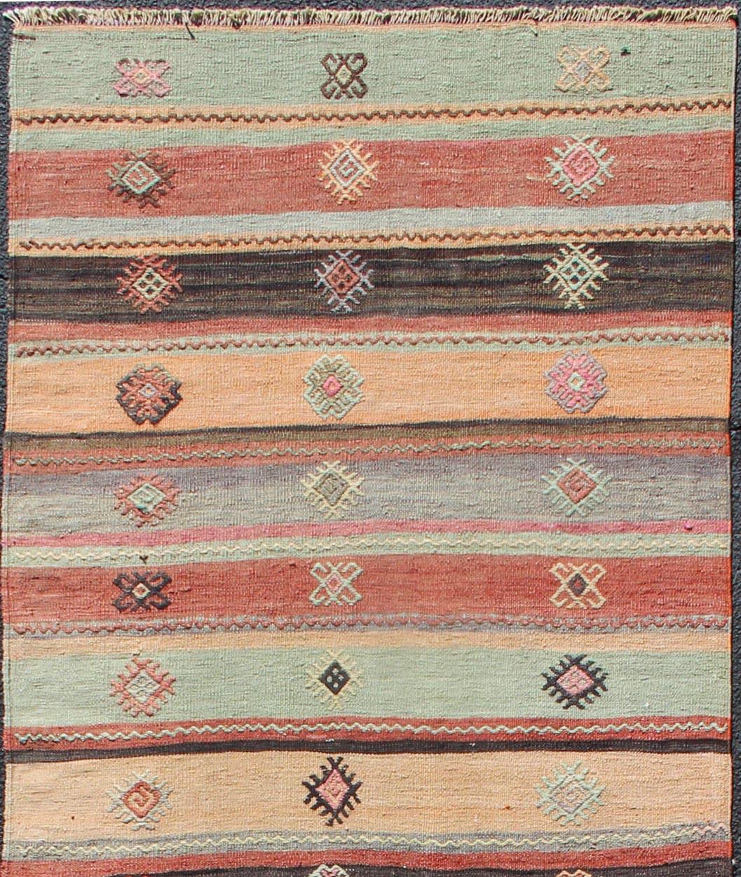 Geometric stripe design Kilim runner in multi-colors, rug TU-NED-628, country of origin / type: Turkey / Kilim, circa 1950

This vintage Kilim displays an array of designs, including a striped pattern and small geometric prints. The designs are