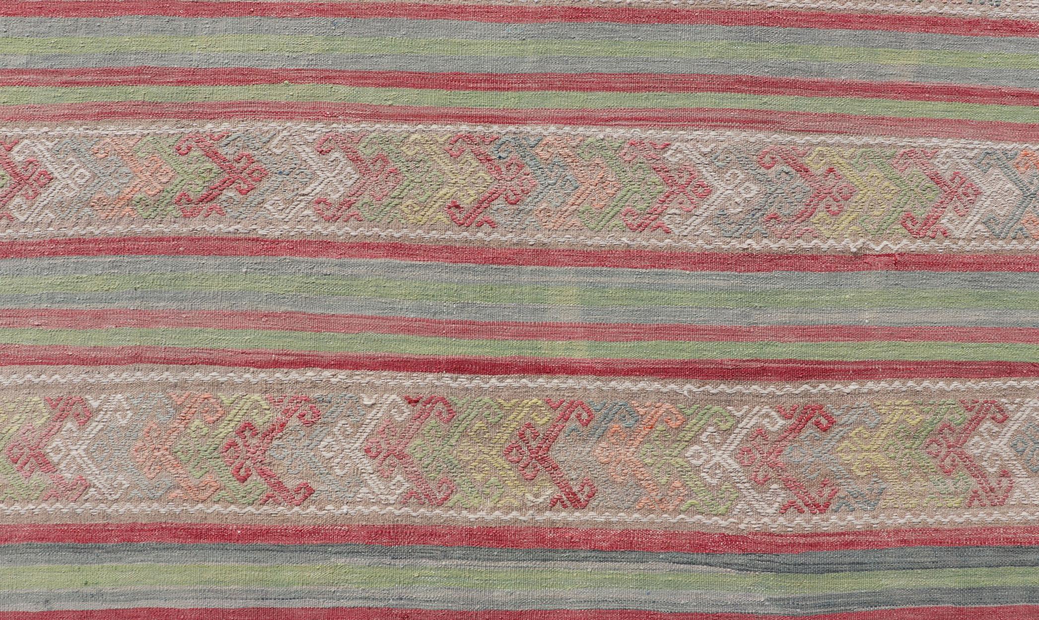 Geometric stripe design Kilim rug in multi-colors, Keivan Woven Arts / rug EN-P13028, country of origin / type: Turkey / Kilim, circa 1950

Measures: 7 x 10'3 

This vintage Kilim displays an array of designs, including a striped pattern and