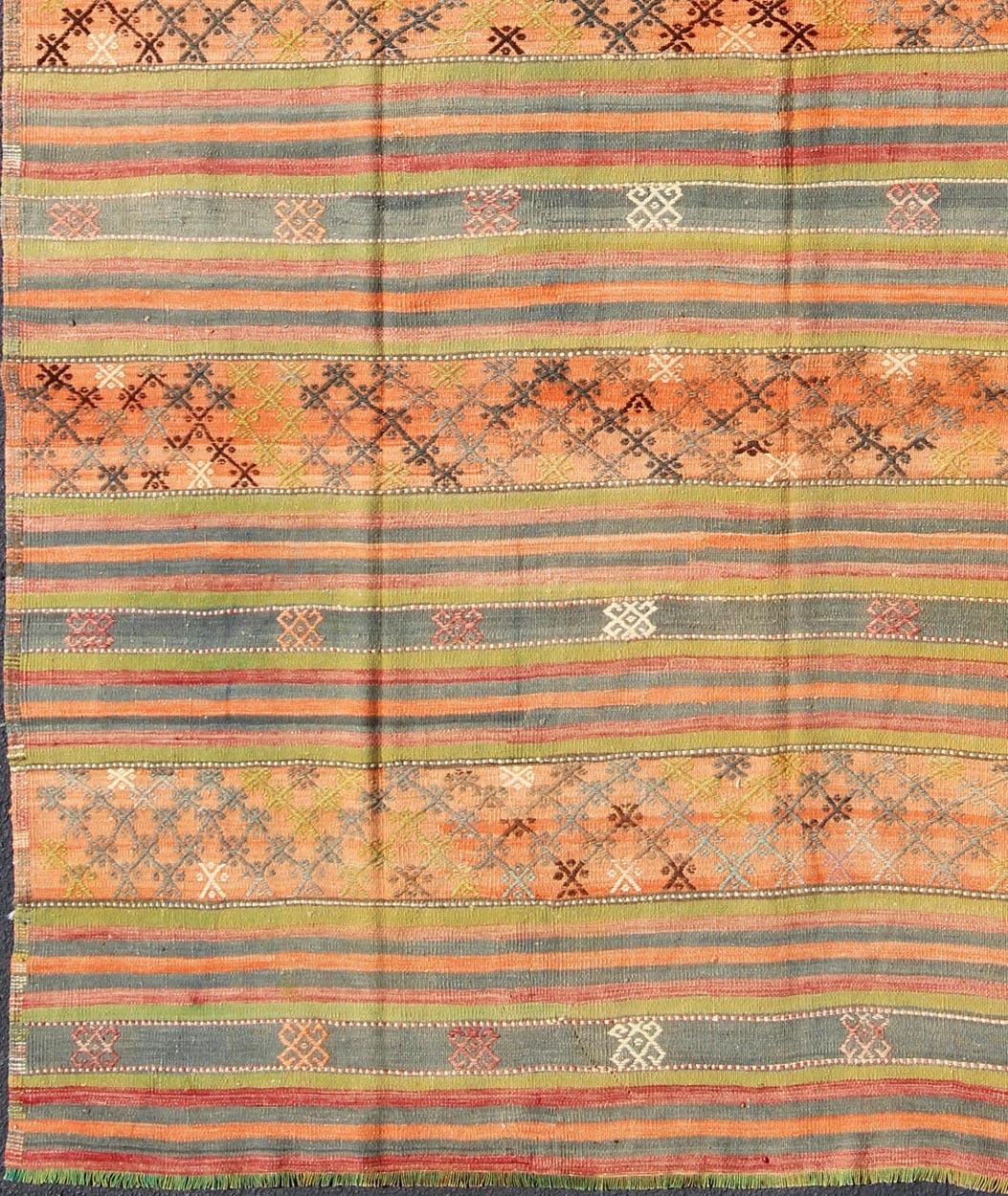 Geometric stripe design Kilim in multi-colors, rug tu-ned-25, country of origin / type: Turkey / Kilim, circa 1950

This vintage Kilim displays an array of designs, including a striped pattern and small geometric prints. The designs are rendered in
