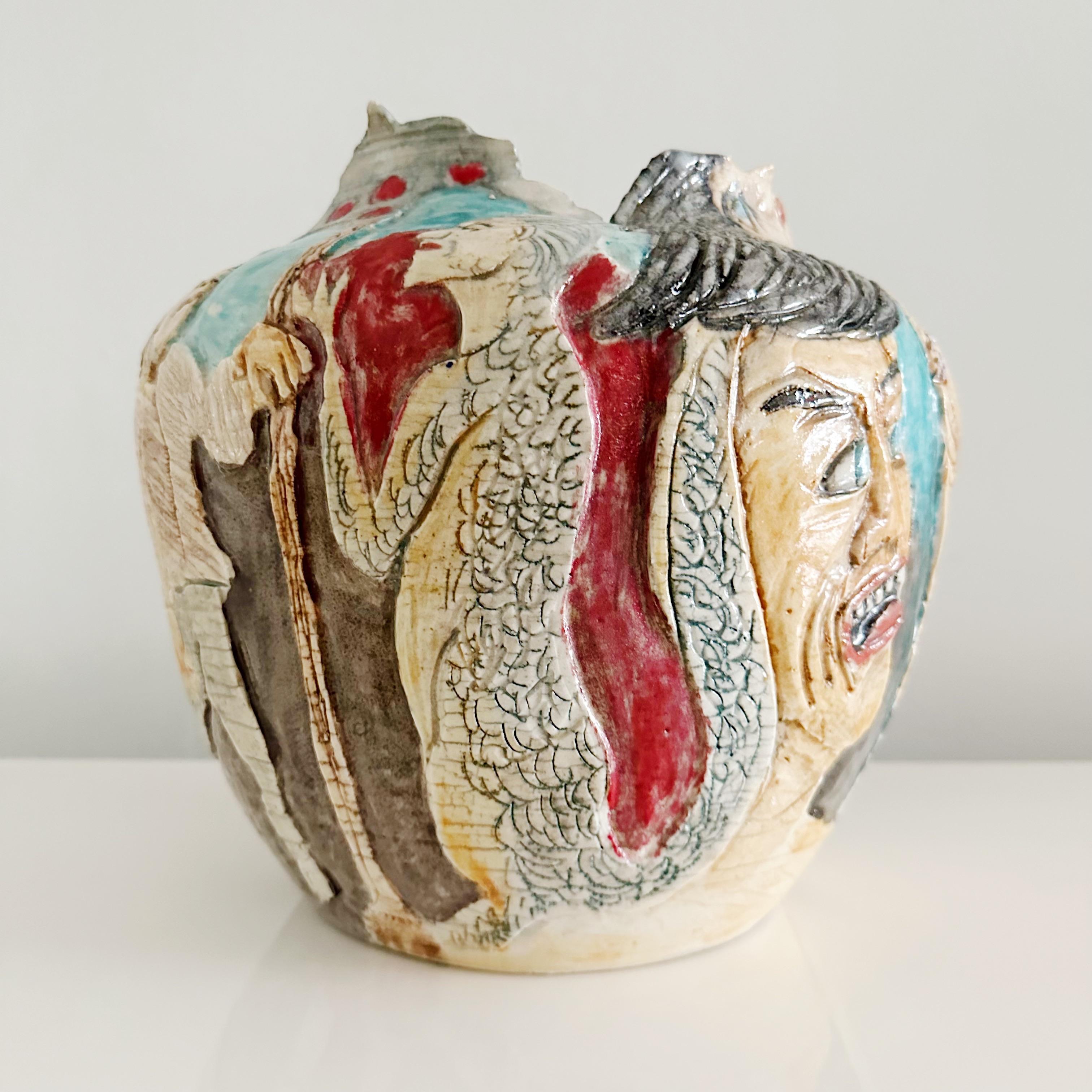 Hand made studio vase depicting different colorful characters, some naked, some not. This vase has and illegible signature on the underside and is dated 3/84.