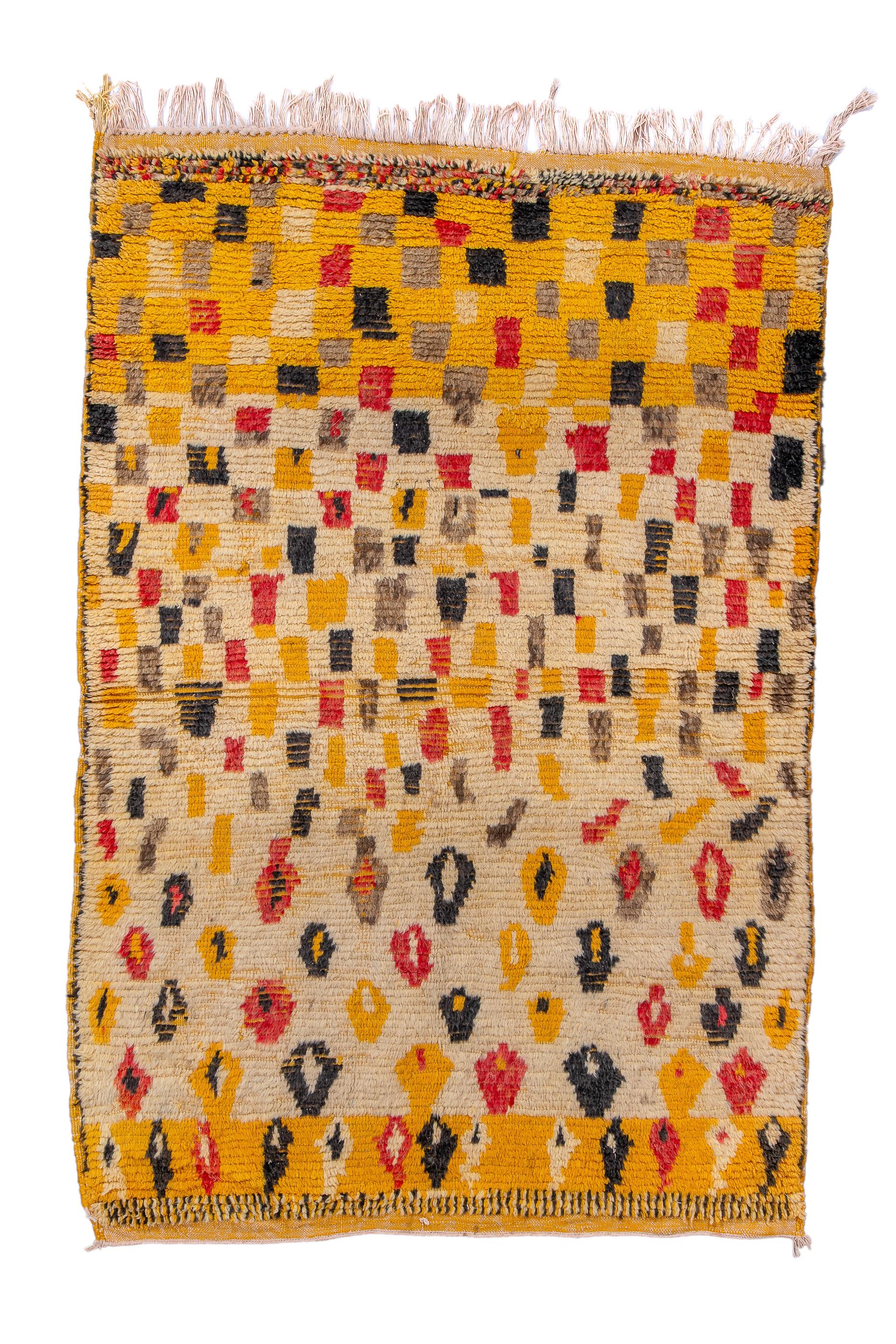 This coarsely woven rustic Moroccan rug stars with a yellow field, switches to ecru and then goes back to yellow at the top, all the while displaying wonky cypresses, irregular colour patches and finally a relatively ordered multi-chromatic