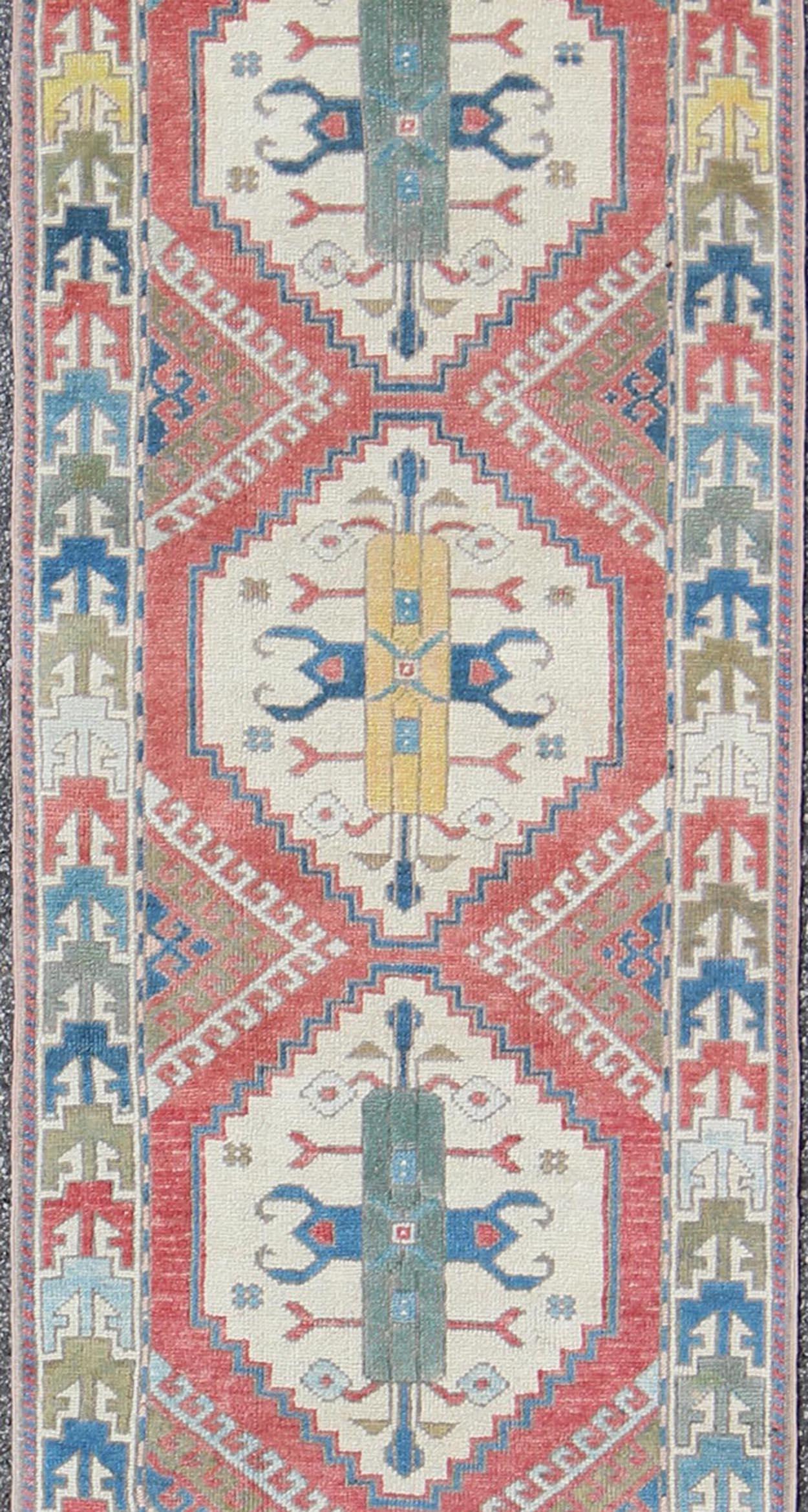 Vintage Oushak runner from Turkey with Medallion design in various blue, soft red, green, yellow and tan tones, rug EN-165744, country of origin / type: Turkey / Oushak, circa 1940

This vintage Turkish runner from Turkey features an arrangement of