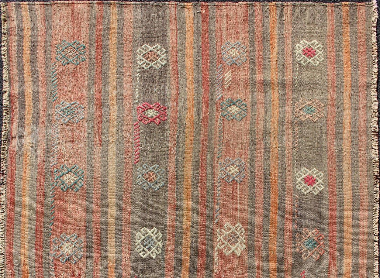 Vertical stripe design flat-weave Kilim from Turkey vintage in orange, red, brown, gray, and cream, rug TU-NED-605, country of origin / type: Turkey / Kilim, circa 1950.

Woven during the mid-20th century in Turkey, this designer Kilim is