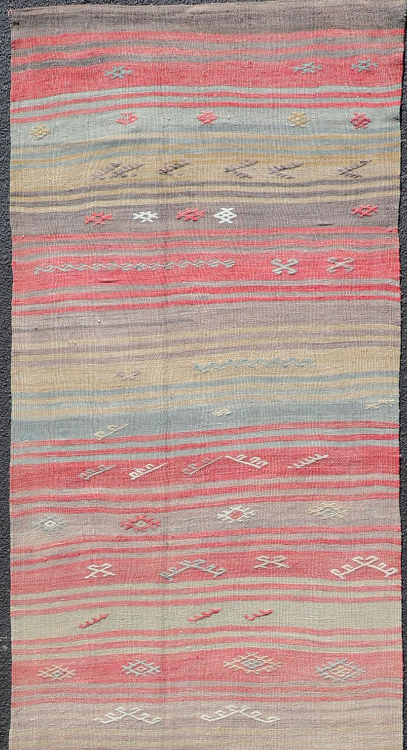 Stripe design flat-weave vintage runner from Turkey, Keivan Woven Arts / rug EN-1311, country of origin / type: Iran / Kilim, circa 1940.

Featuring a dynamic stripe design, this unique 1940s Kilim runner showcases an array of vibrant color tones,