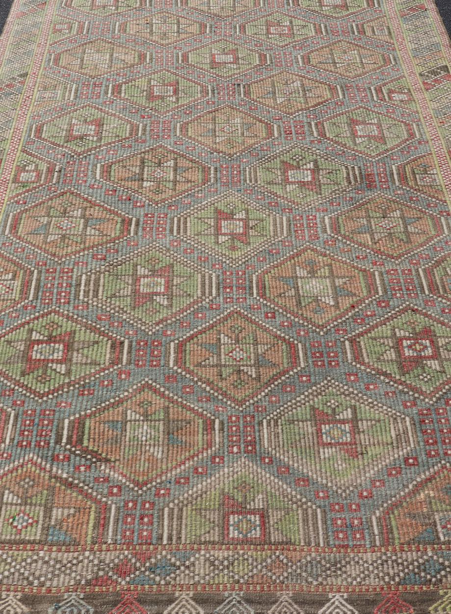 Colorful vintage Turkish flat-weave Tribal Motif Kilim with Embroideries. Keivan Woven Arts / rug /EN-178922 Mid-20th Century 

This Embroidered kilim rug from Turkey features an all-over layered diamond and geometric design rendered in natural