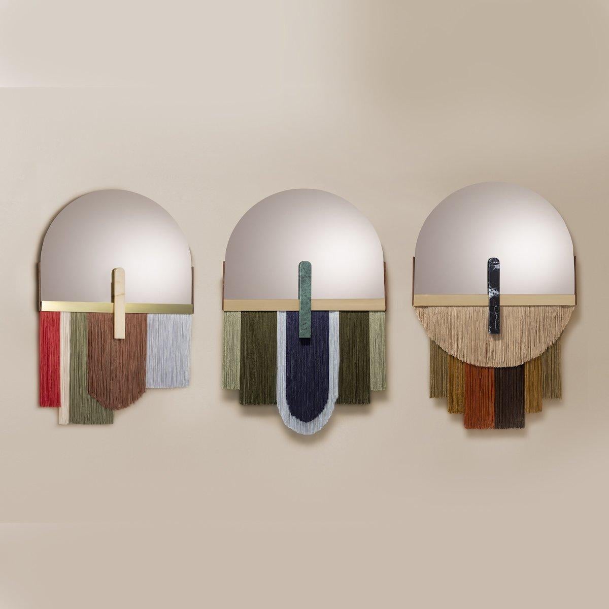 Souk papaya  Colorful Wall Mirror by Dooq
Dimensions
W 61 x H 97 cm

Materials and finishes
Mirror in colored glass, edge in brass, detail in marble, fringe in fabric, back of the mirror in wood.
Product
Souk papaya mirror is a flamboyant and