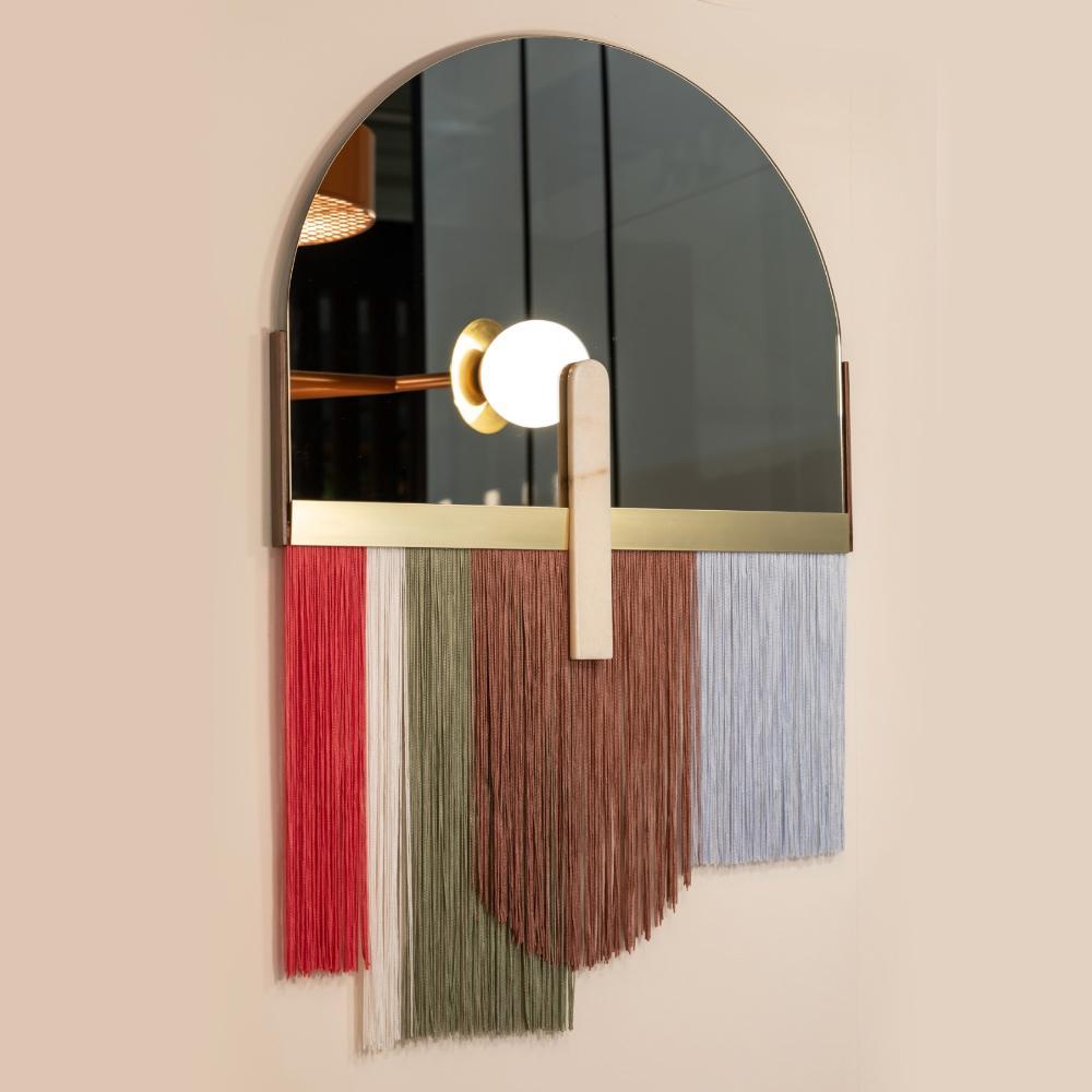Colorful wall mirror by Dooq

Dimensions:
W 61 x H 97 cm

Materials and finishes
Mirror in colored glass, edge in brass, detail in marble, fringe in fabric, back of the mirror in wood.
Product
Souk papaya mirror is a flamboyant and elegant