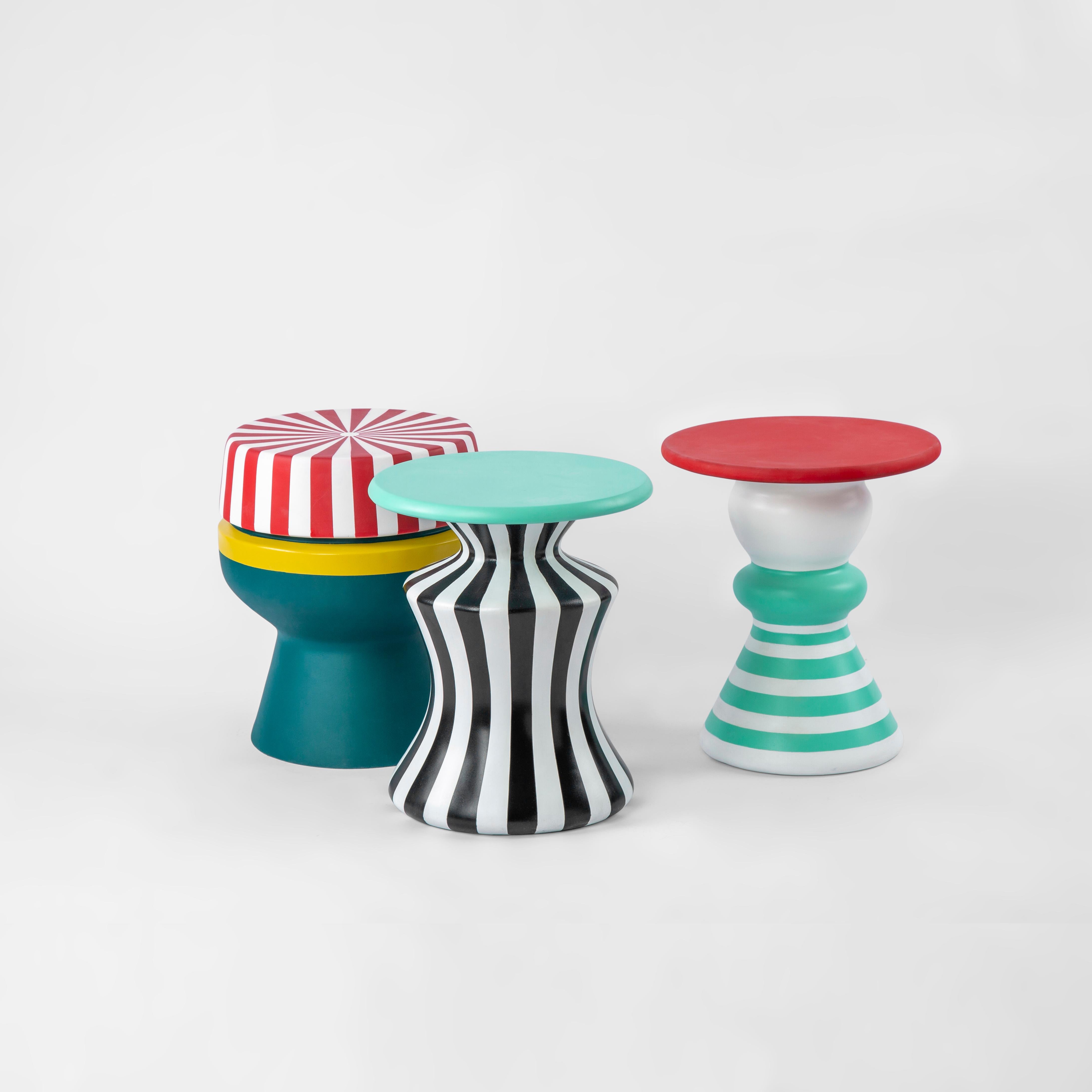 Colorful weather-resistant fiberglass outdoor side table - Nubian Mama Doll.

This family of stools and side tables are as quirky and whimsical as the characters found in Nubian fables and folklore. They come in a range of color patterns that