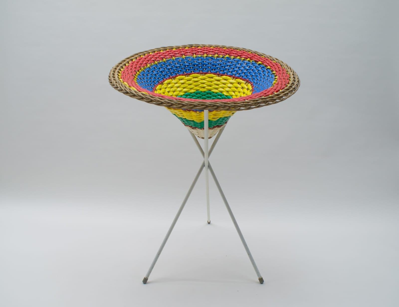 Wicker, metal and colorful plastic hose.

Extremely rare and never seen before.

Very decorative on a tripod metal stand. This one has traces of use. Can be easily repainted in any other color. 

Measures: Front height 84cm (33