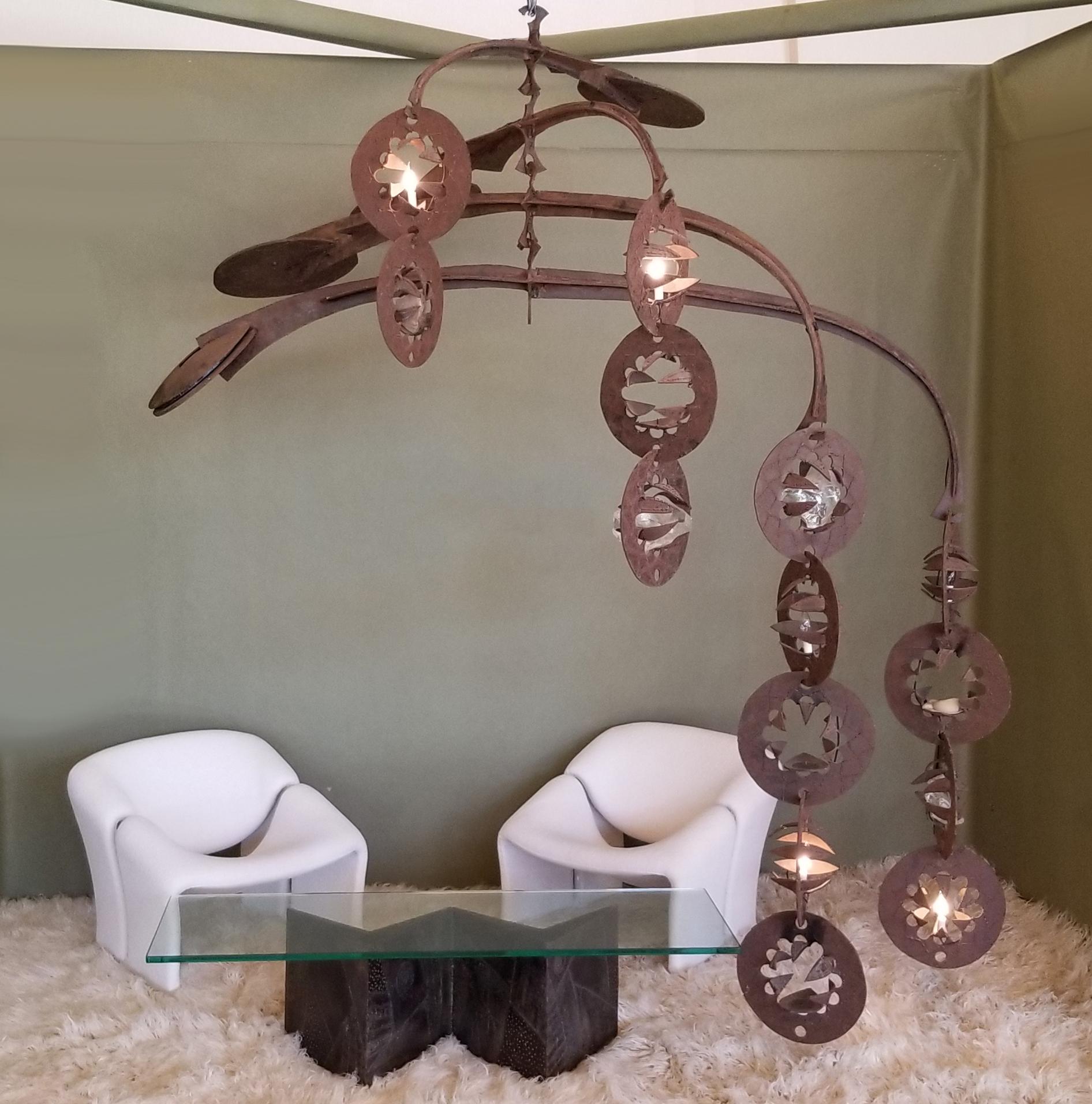 This corten steel mobile was created by Gene Montez Flores during the early 1960s in his California studio. It was his largest private residential commission. The sculpture consists of four massive arms with saucer shaped steel counterweights on one