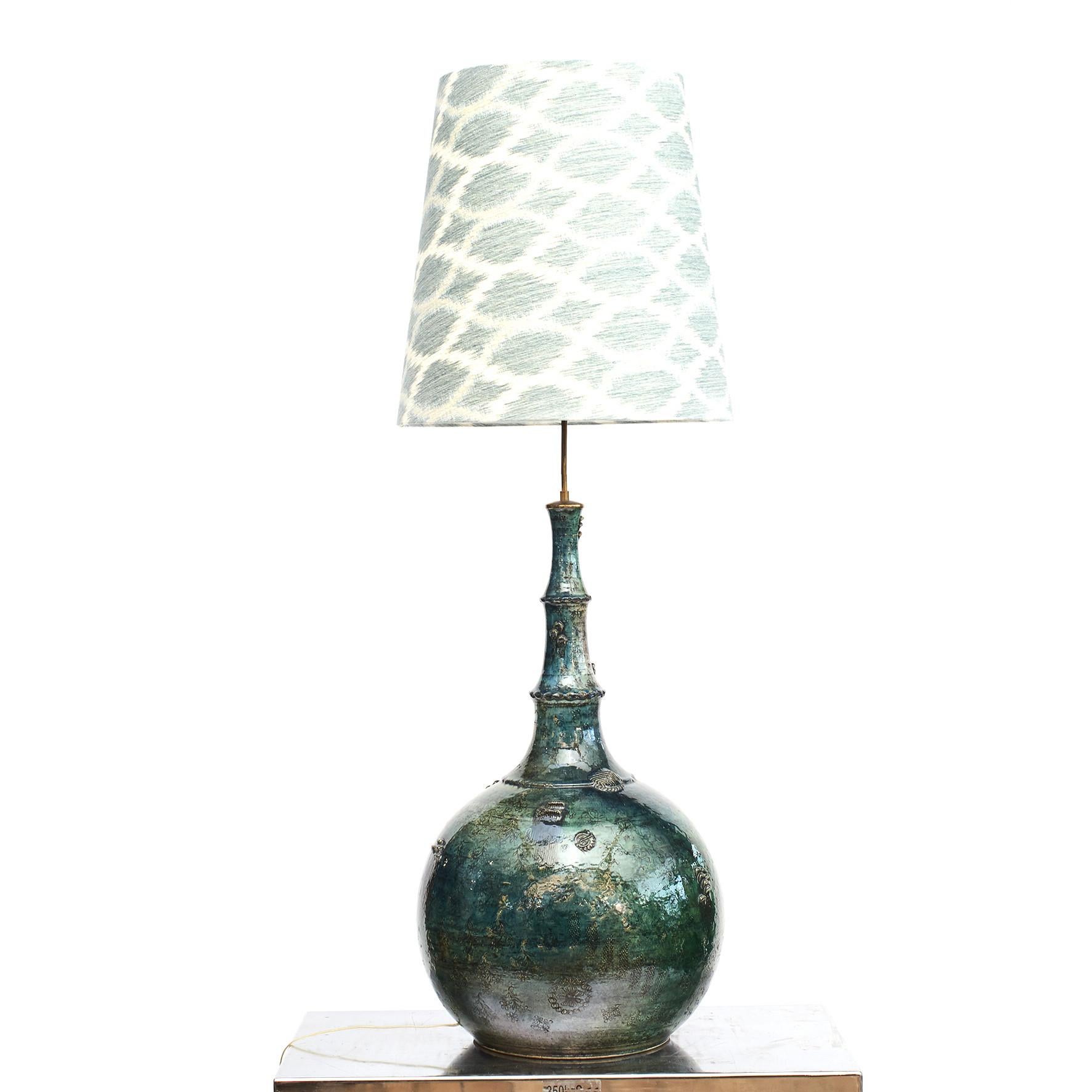 Bjørn Wiinblad 1918-2006.
Colossal 'one of a kind' ceramic lamp by Bjorn Wiinblad. Glaze in polychrome shades of blue and green. Decorated with foliage, grapes etc.
New lampshade in ikat fabric from Jane Churchill.
A very beautiful and decorative