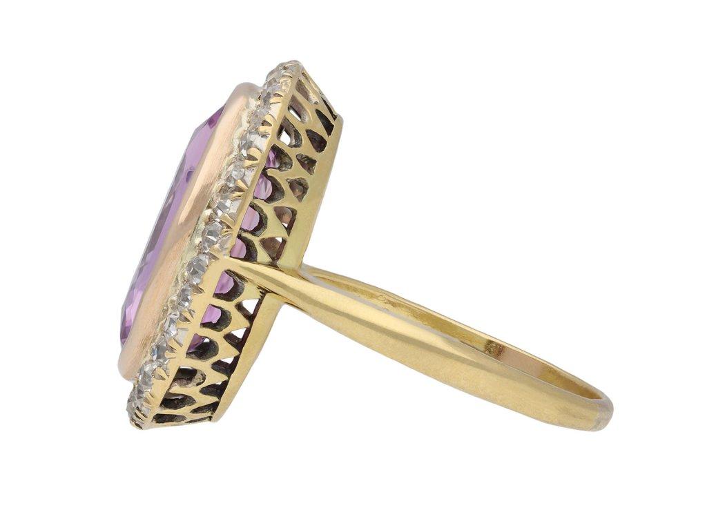 Colour change Ceylon sapphire and diamond ring. Set to centre with an oval old cut natural unenhanced pinkish purple colour change Ceylon sapphire, pinkish purple in daylight and pink in incandescent light, in an open back rubover setting with a