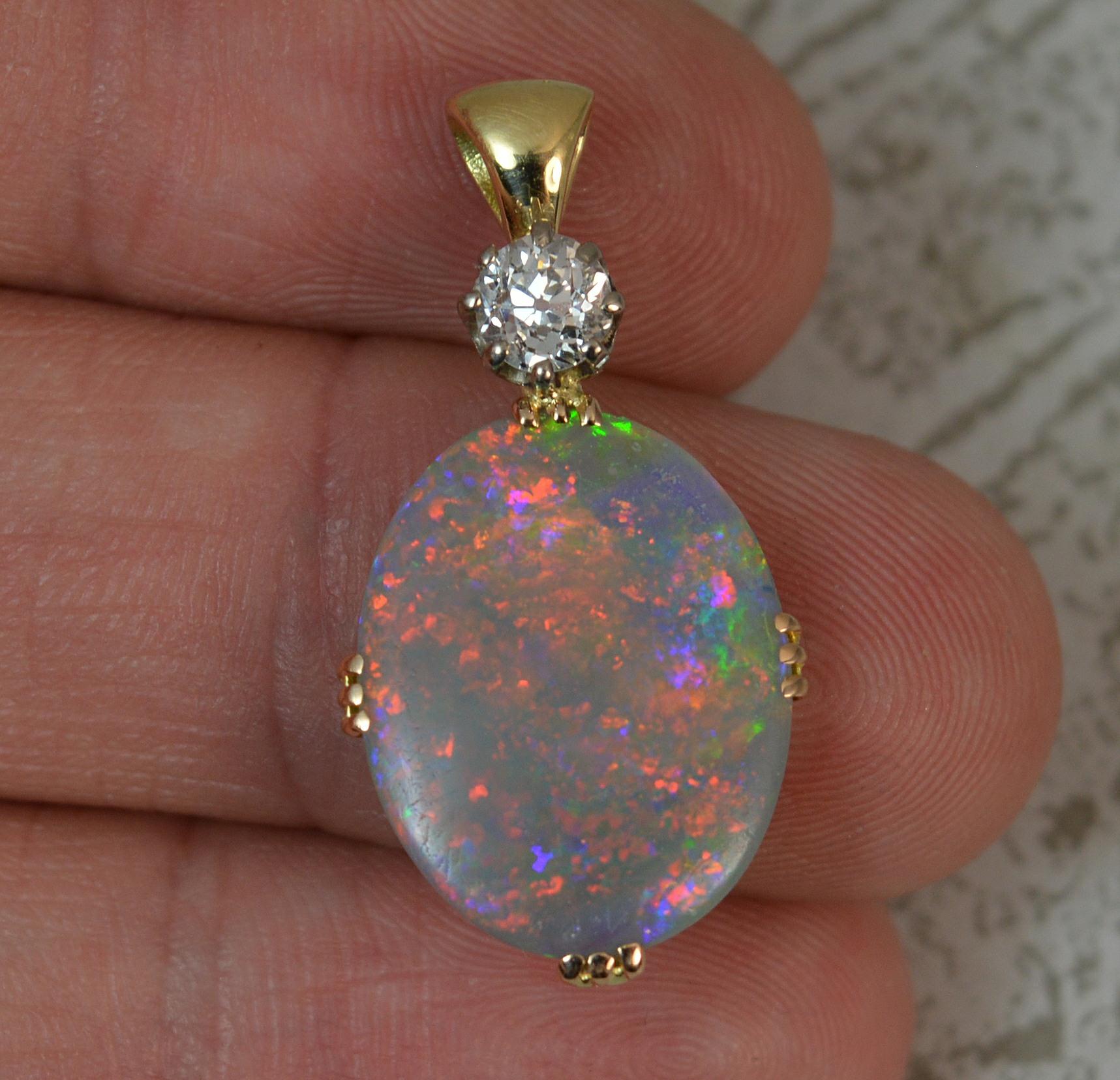A fantastic quality natural Black Opal and Diamond pendant.
18 carat yellow gold example.
Designed with an old cut diamond to top, just under half a carat. Clean, bright and sparkly.
Below is an oval shaped black opal with a wide variety of colour