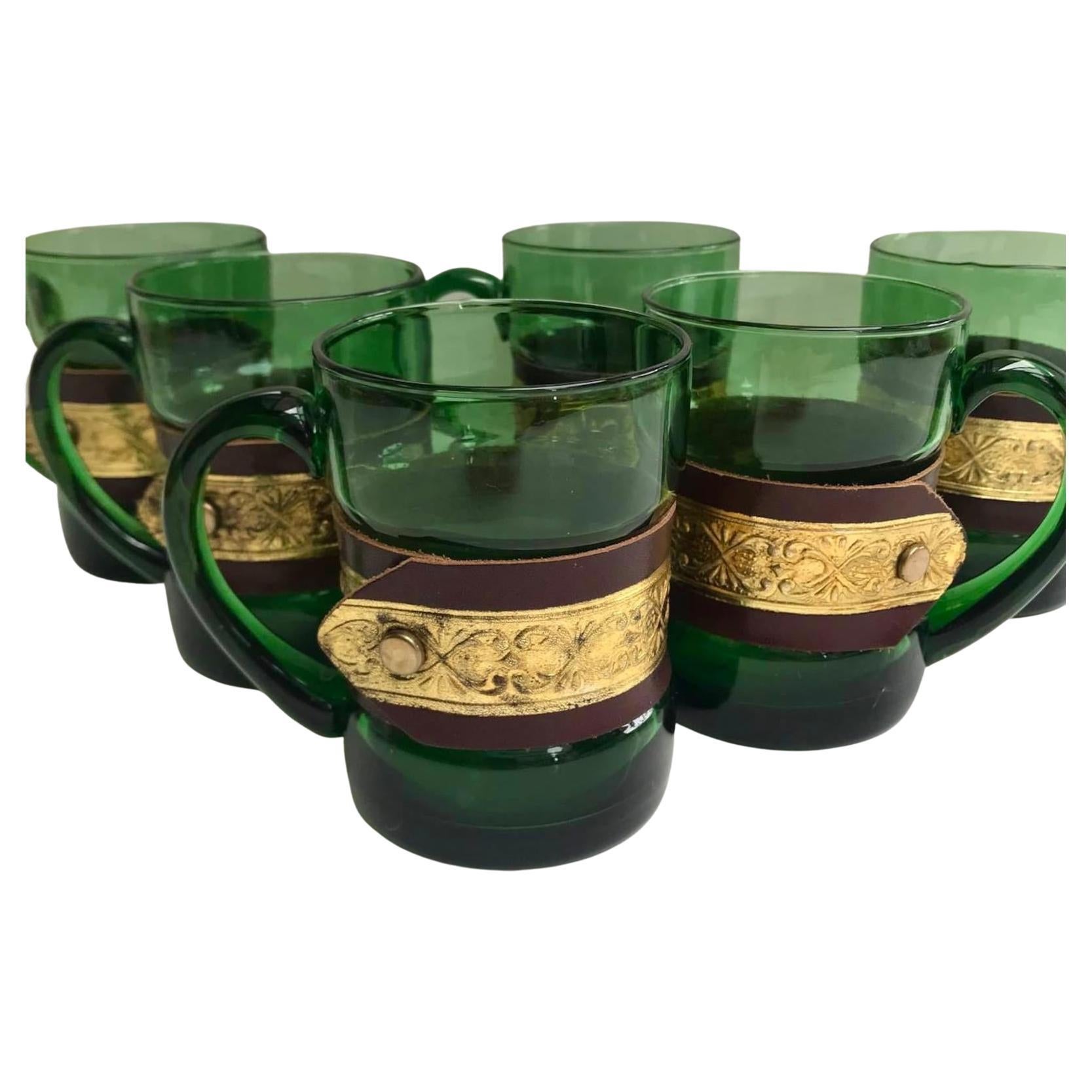 Colourful vintage glass mugs in a Beautiful Emerald Color.

The handmade decorative belts are detachable.

France. 

Set of 6 pieces. 

The Price for the set of 6.

In excellent condition, no chips, cracks or crazing. 

Size:

Height -