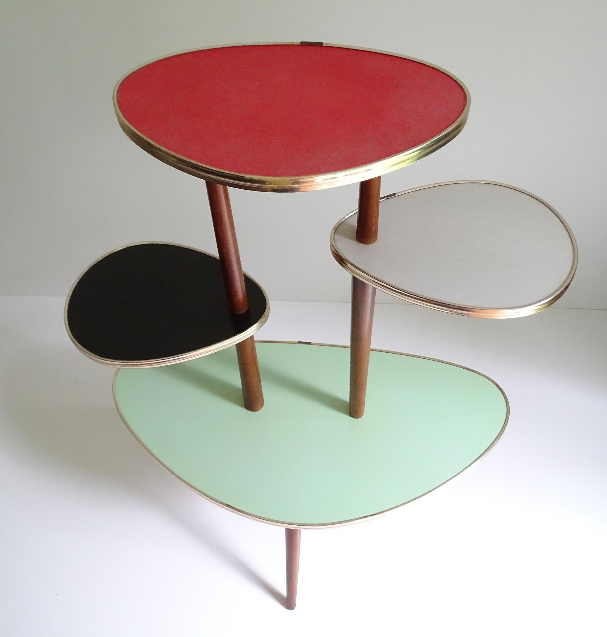 Stunning Mid-Century Modern flower / plant stand. This is an extremely rare quite large model with stunning colorful combination
It features 1 large triangular lower and 4 smaller plates, arranged in clockwise fashion on 3/4 wooden circle stand, 3