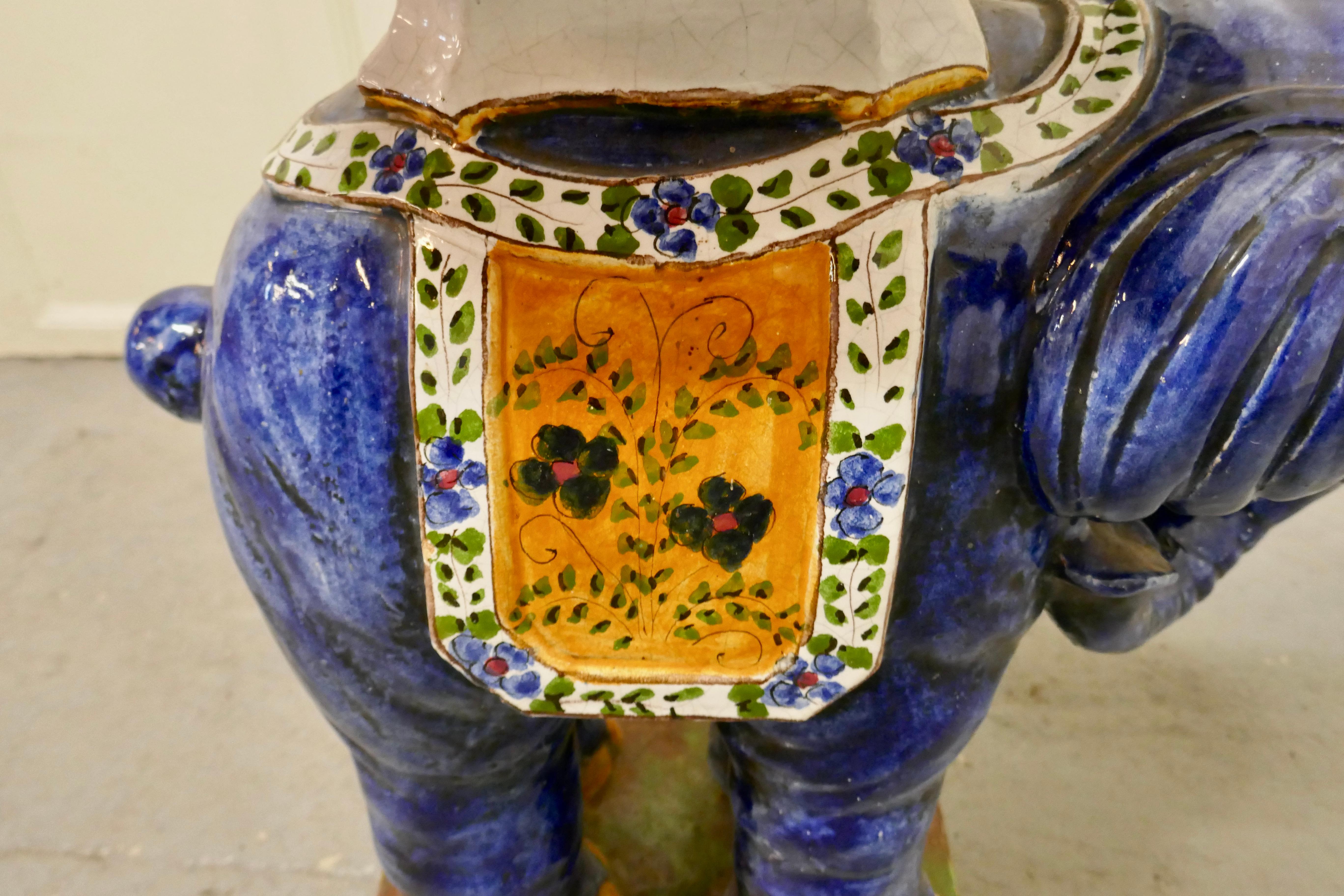 Colourful North African terra cotta elephant statue seat 

A very bright and attractive piece of Folk Art from North Africa, he dates from the late 19th Century and is painted in the brightest of Cobalt blue and Bright colours
In general good