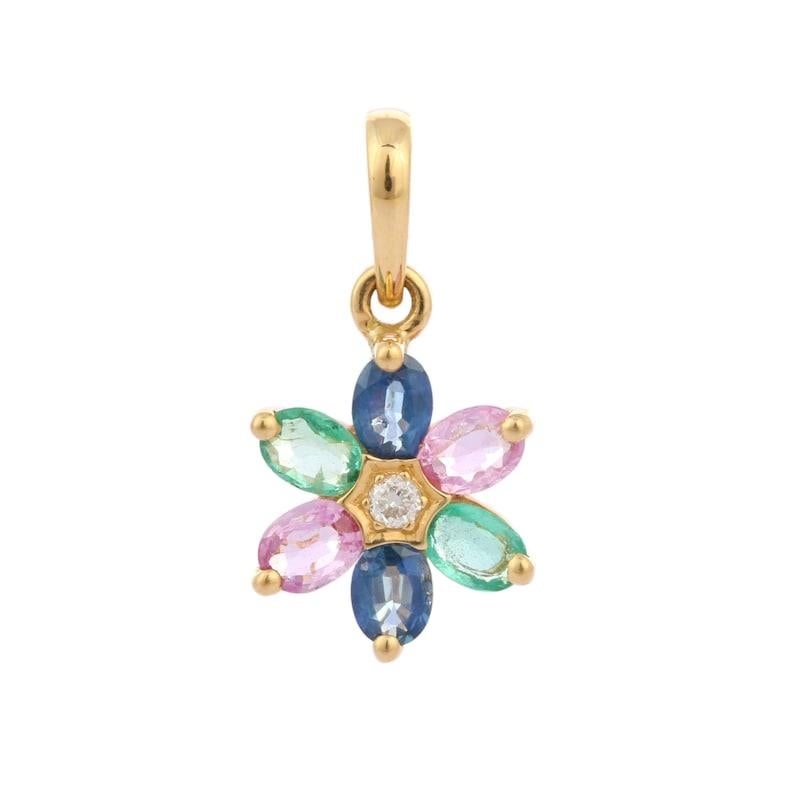 Multi Sapphire and Emerald Flower Pendant in 18K Gold studded with oval cut sapphires and emerald. This stunning piece of jewelry instantly elevates a casual look or dressy outfit. 
Sapphire stimulate concentration and reduces stress and emerald